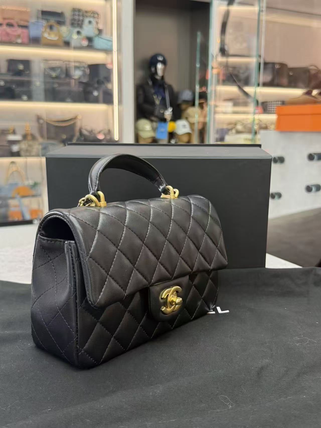 Chanel Top Handle Mini Rectangular Flap Bag in black lambskin leather with antique gold hardware