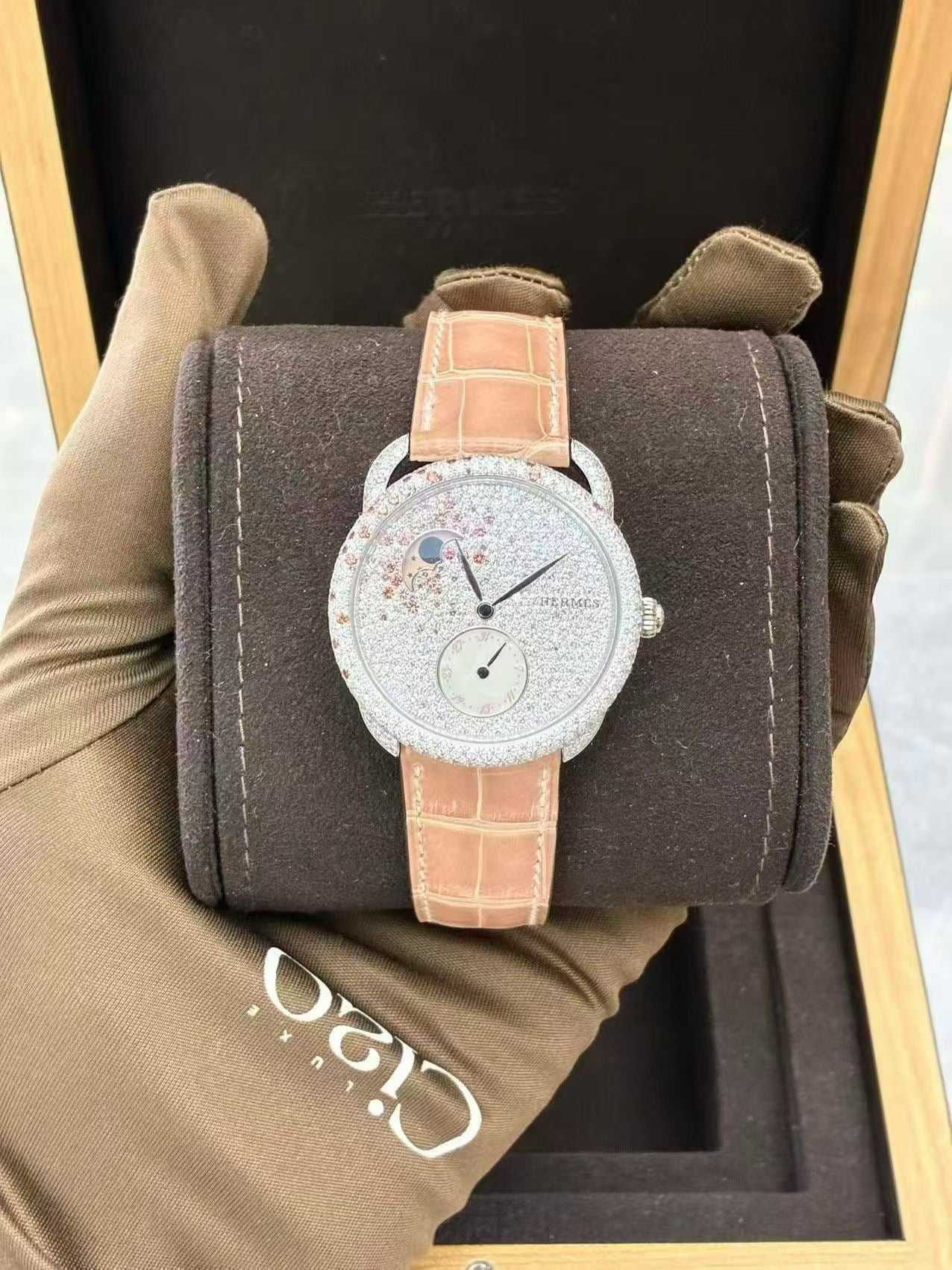 Hermès Arceau Petite Lune watch with a diamond-set white gold case and a matching pink alligator strap