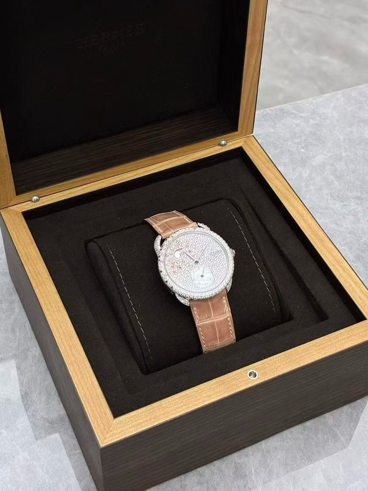 Hermès Arceau Petite Lune watch with a diamond-set white gold case and a matching pink alligator strap