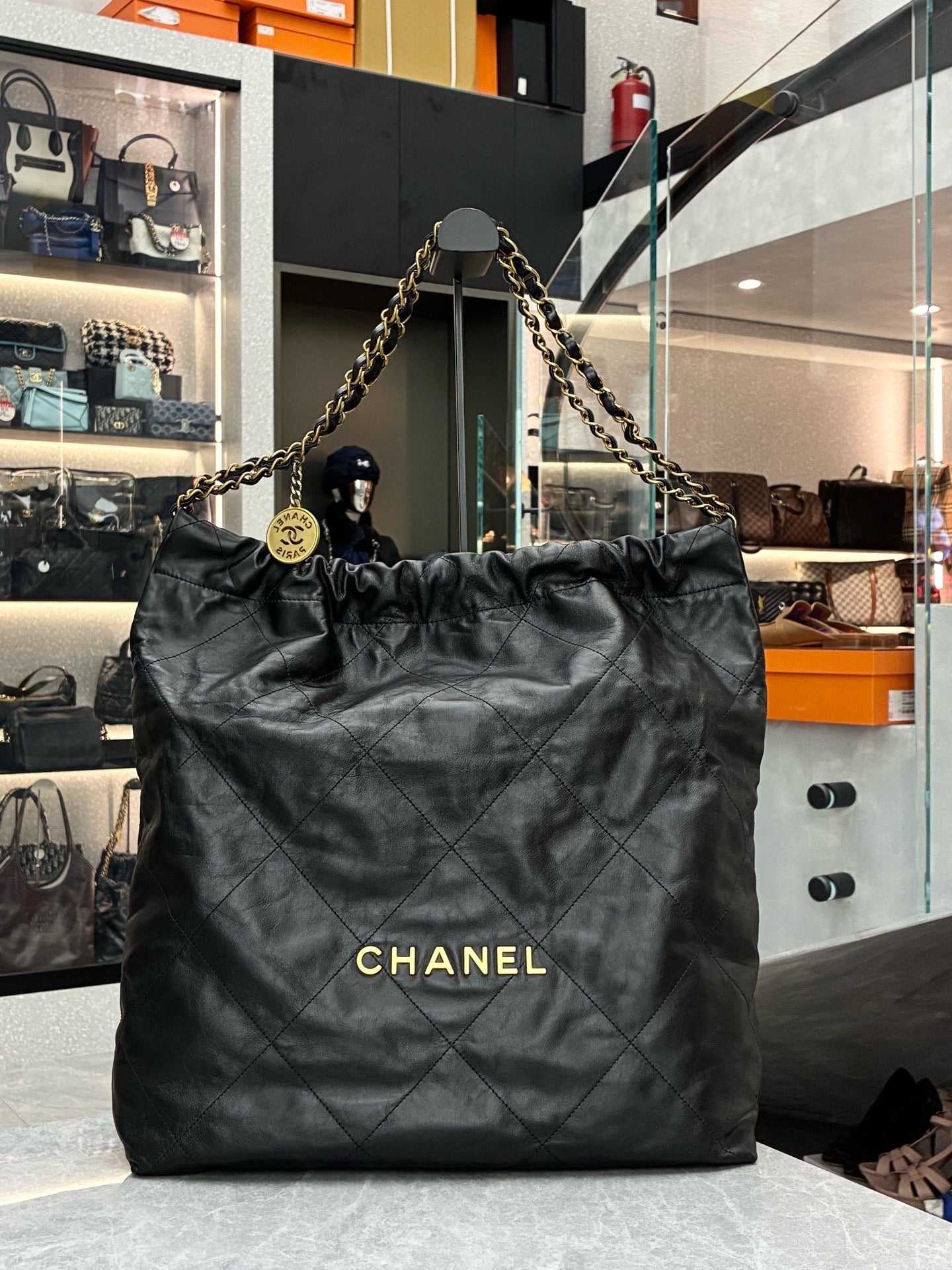 Chanel 22 black handbag crafted from shiny calfskin leather with gold-tone hardware