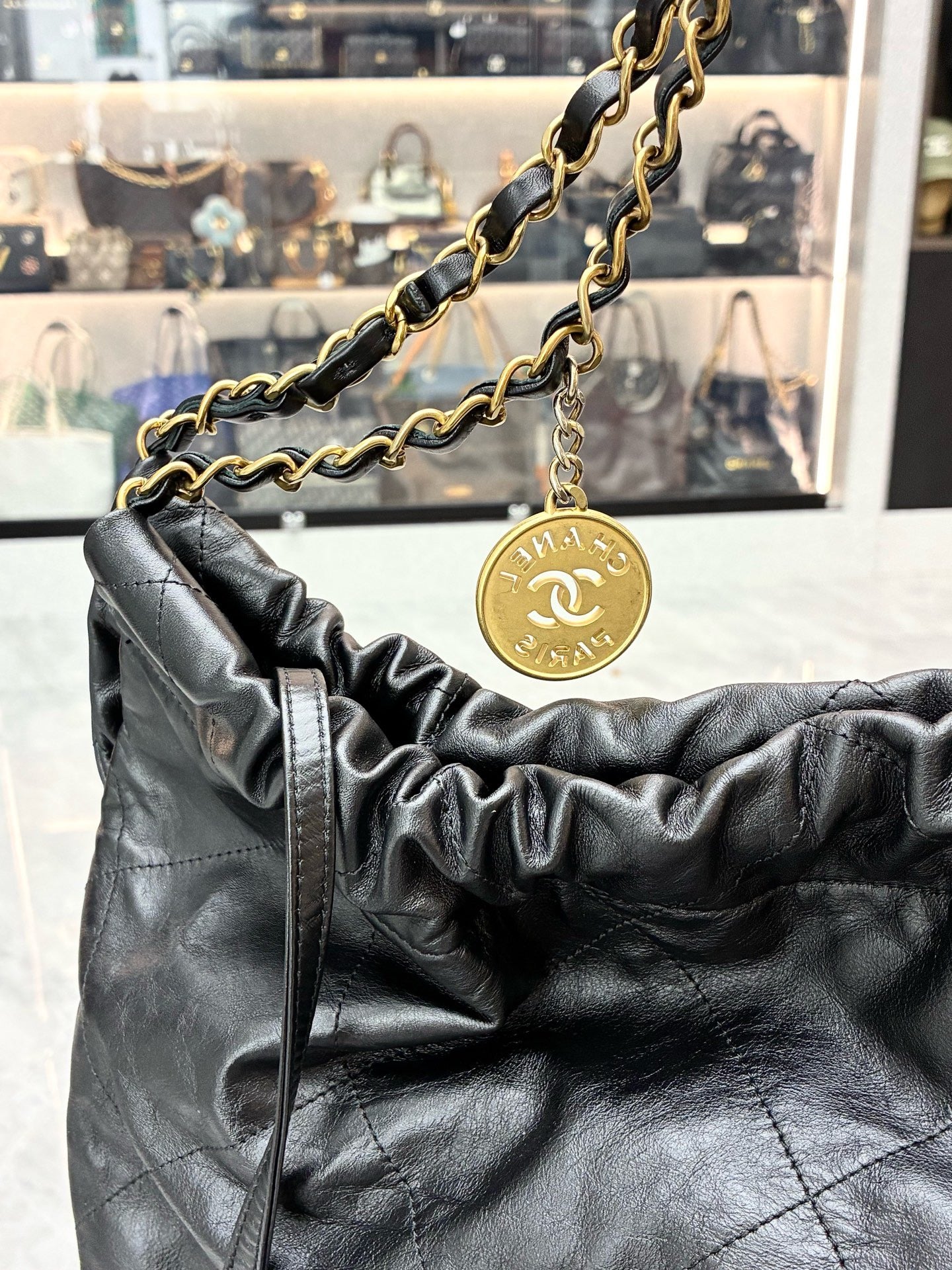 Chanel 22 black handbag crafted from shiny calfskin leather with gold-tone hardware