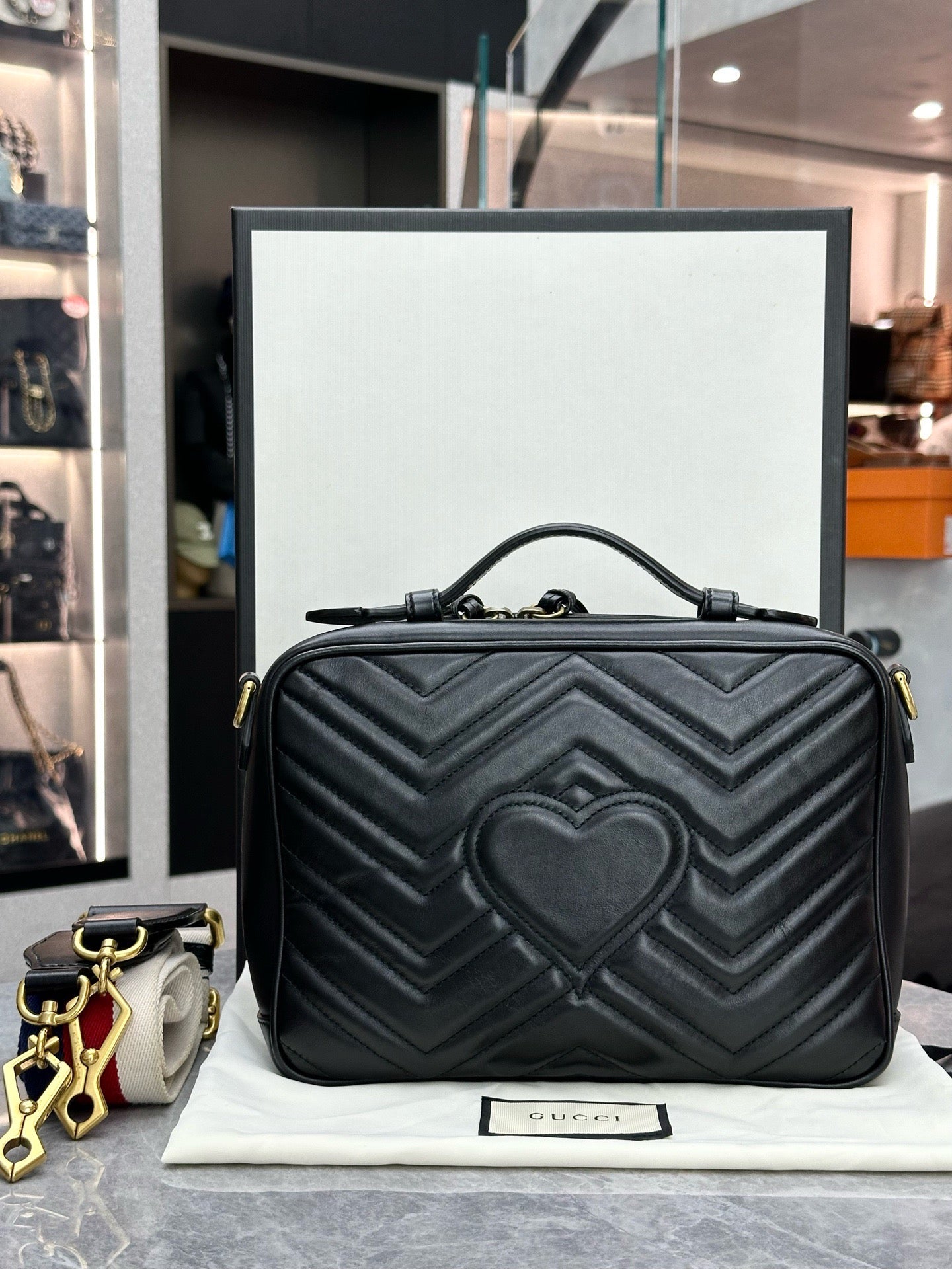 Gucci GG Marmont Small Top Handle Bag in black chevron matelassé leather with gold-toned hardware