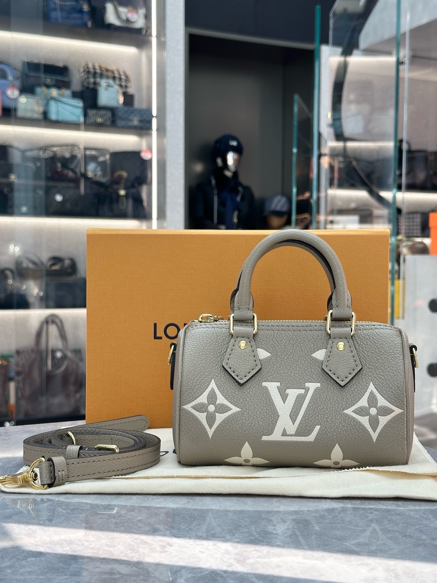 Louis Vuitton Nano Speedy handbag in Tourterelle and Creme embossed Empreinte leather