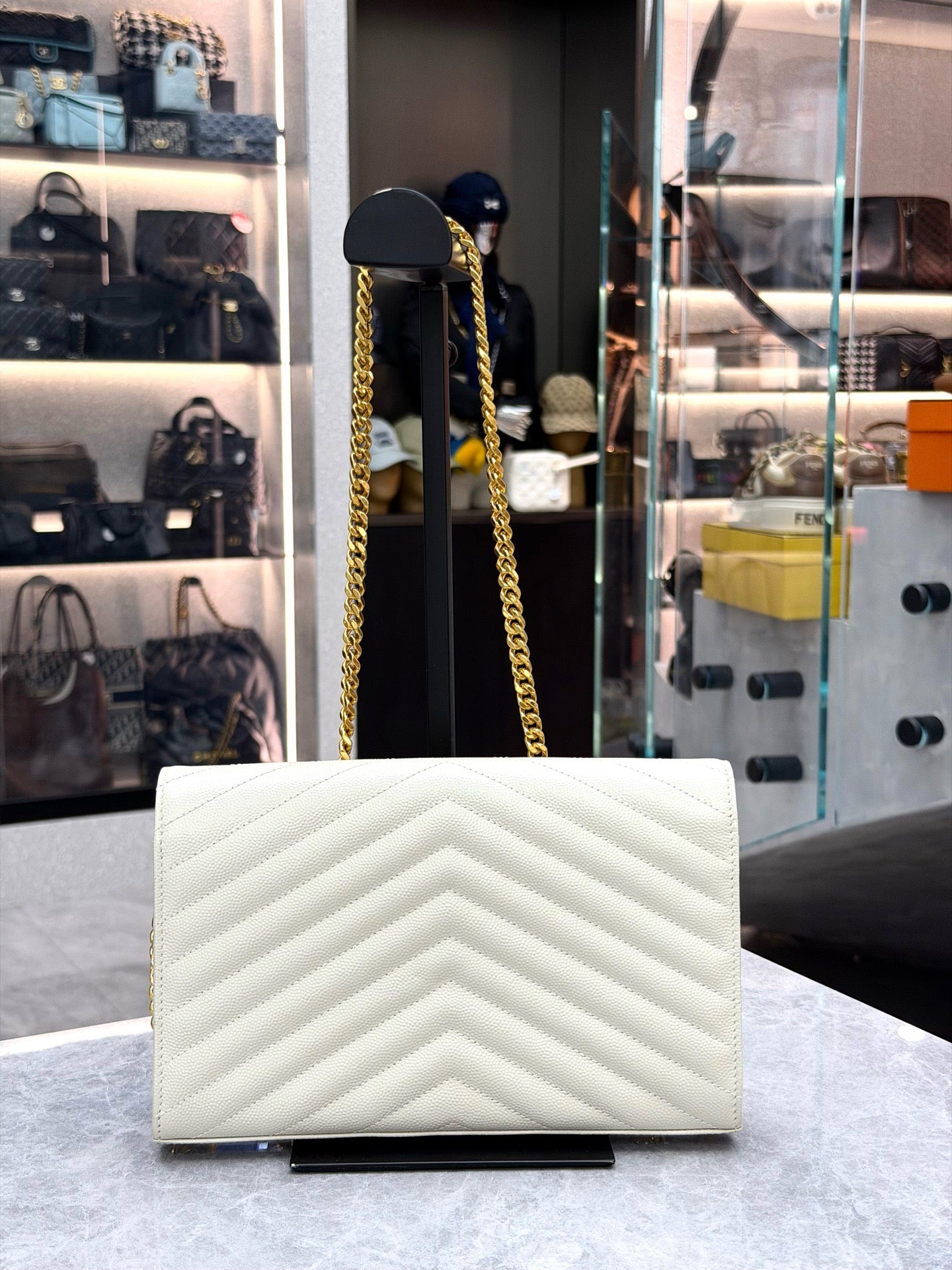Saint Laurent Cassandre Envelope Chain Wallet crafted from white chevron-quilted leather