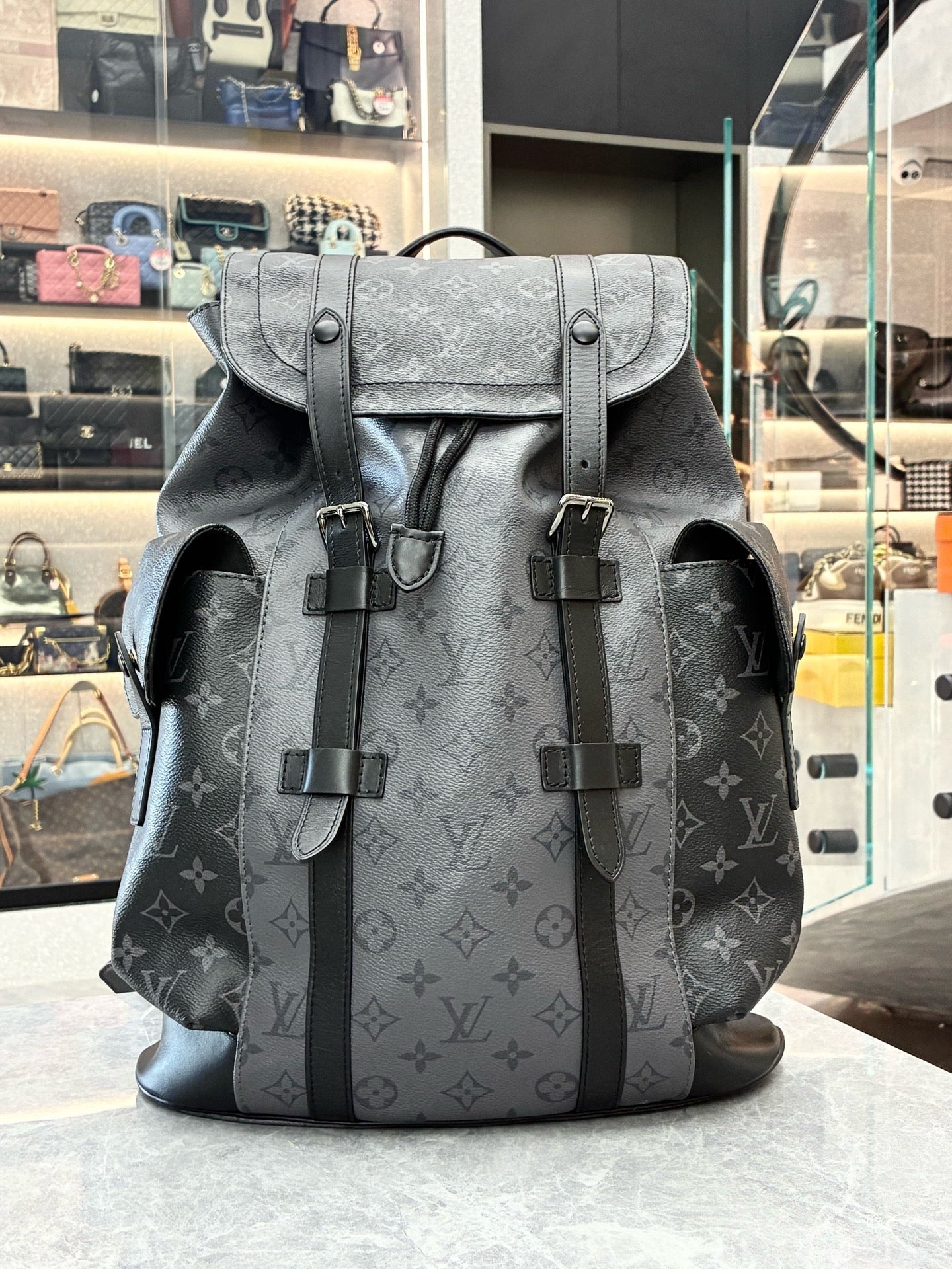Louis Vuitton Christopher MM backpack in Monogram Eclipse canvas featuring black leather trim and silver-color hardware