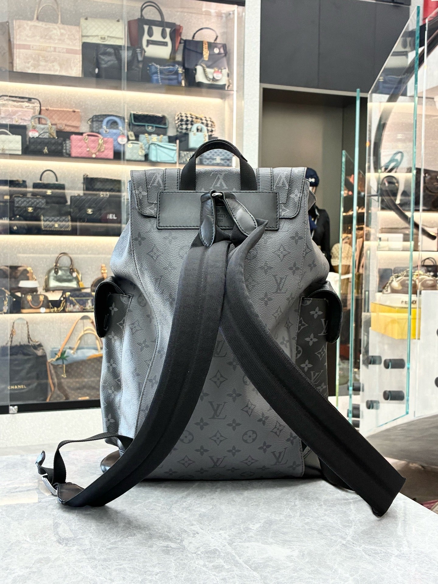 Louis Vuitton Christopher MM backpack in Monogram Eclipse canvas featuring black leather trim and silver-color hardware