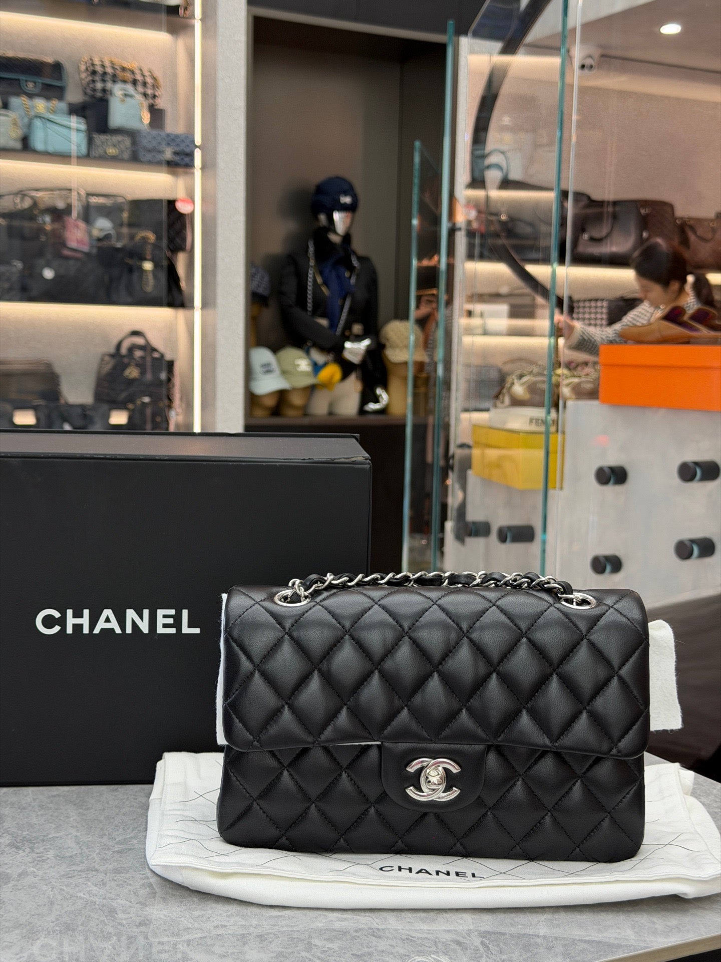 Chanel Classic Double Flap bag is crafted from black diamond-quilted lambskin leather and features silver-tone hardware