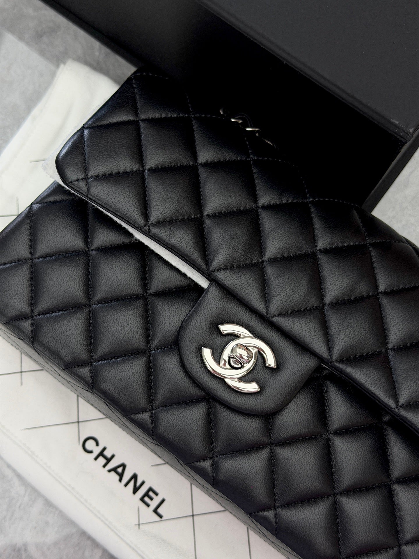 Chanel Classic Double Flap bag is crafted from black diamond-quilted lambskin leather and features silver-tone hardware