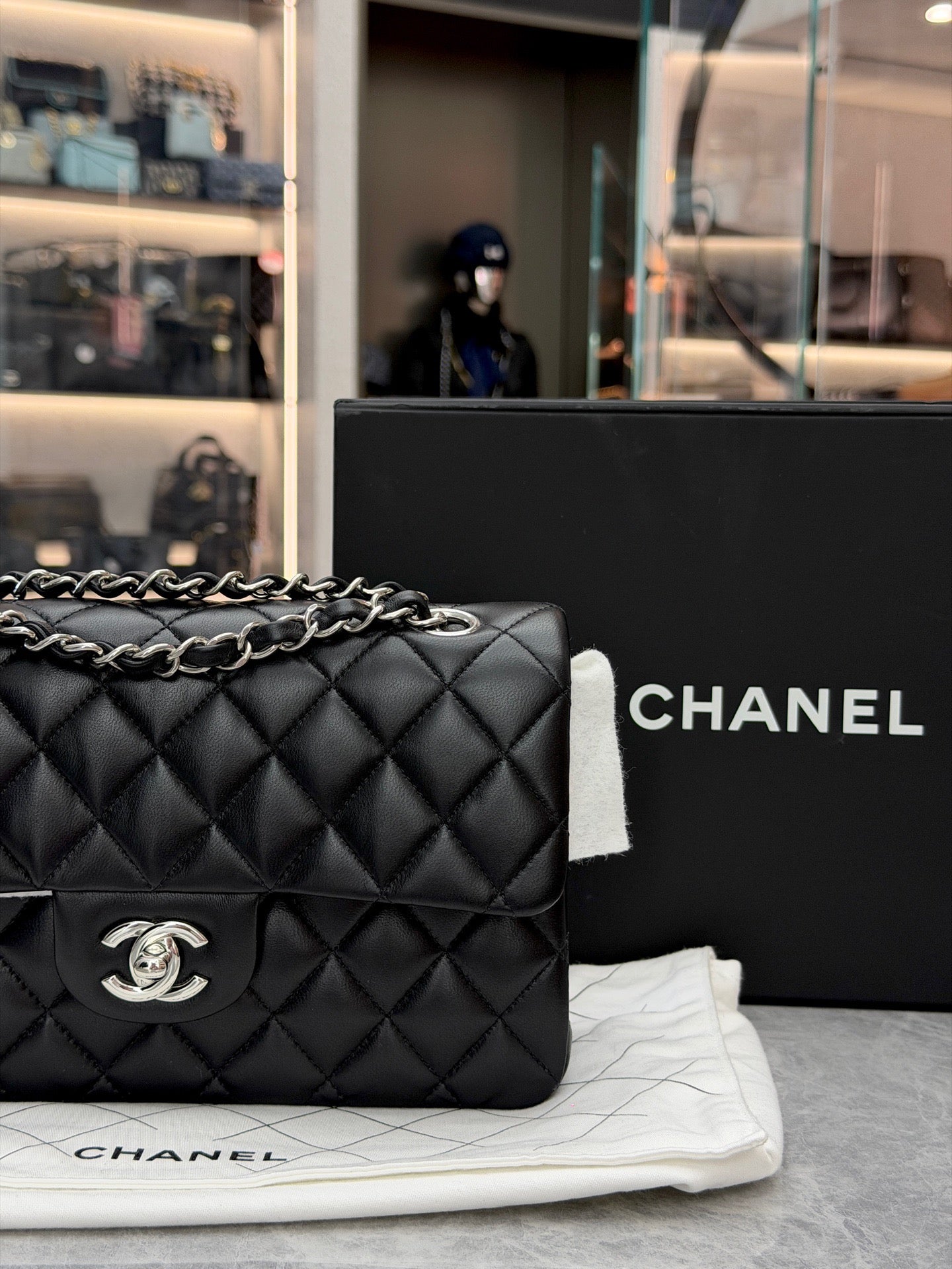 Chanel Classic Double Flap bag is crafted from black diamond-quilted lambskin leather and features silver-tone hardware