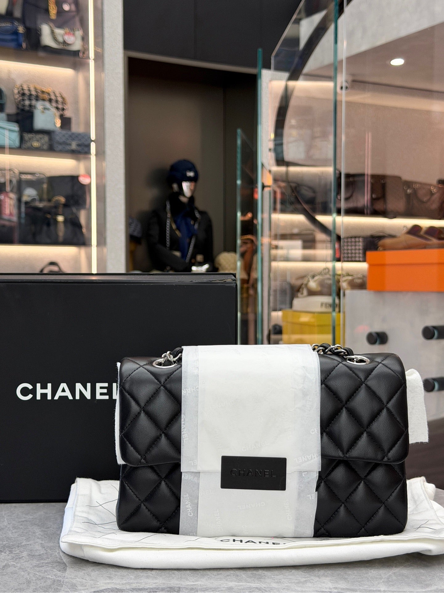 Chanel Classic Double Flap bag is crafted from black diamond-quilted lambskin leather and features silver-tone hardware