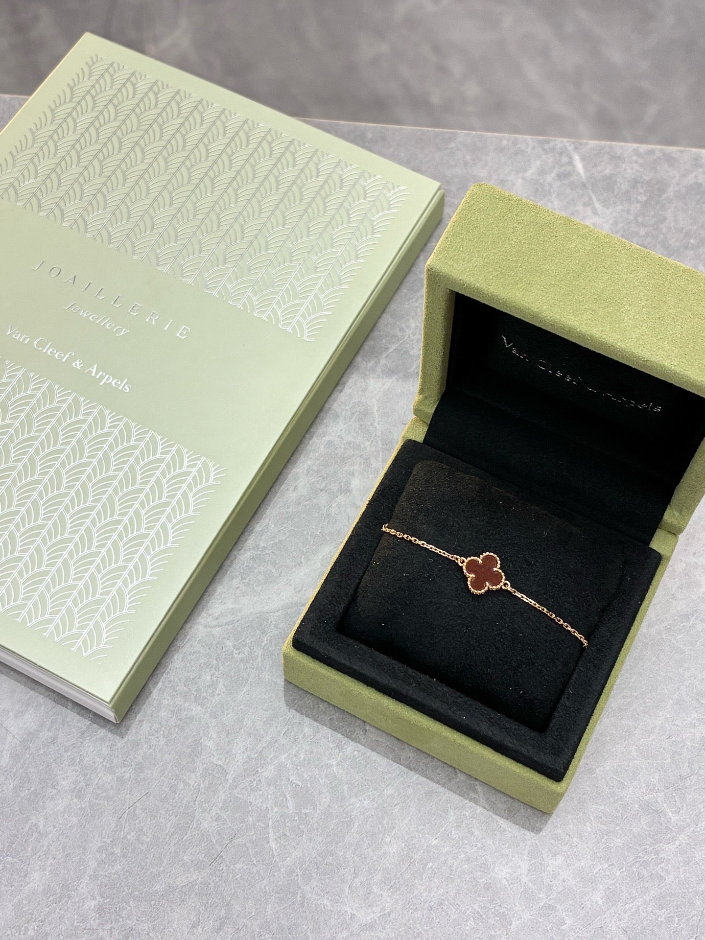 Van Cleef & Arpels Sweet Alhambra bracelet features a single clover motif crafted from red carnelian and 18K rose gold