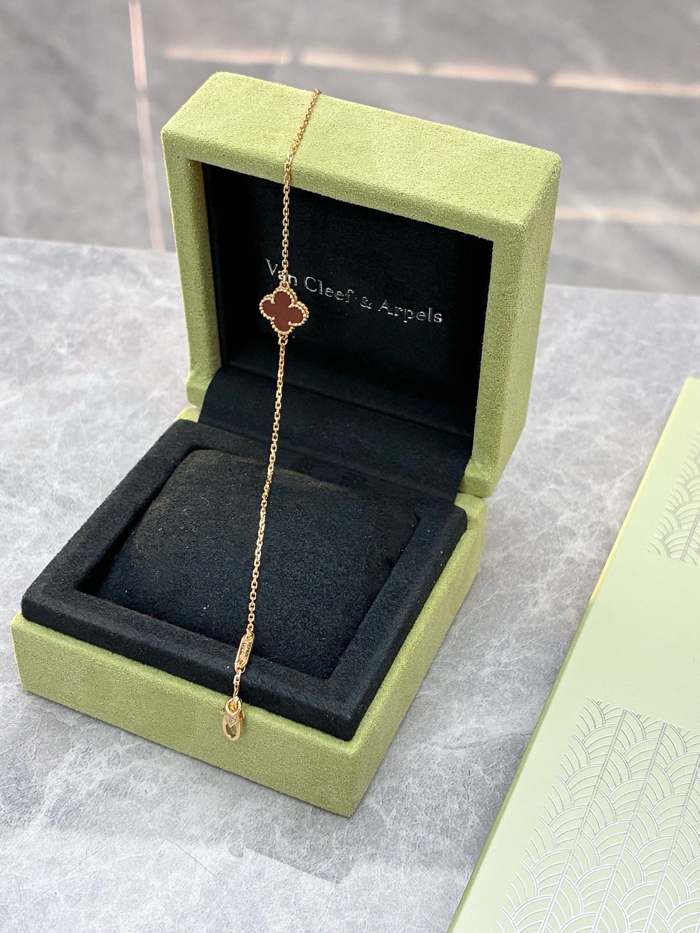 Van Cleef & Arpels Sweet Alhambra bracelet features a single clover motif crafted from red carnelian and 18K rose gold