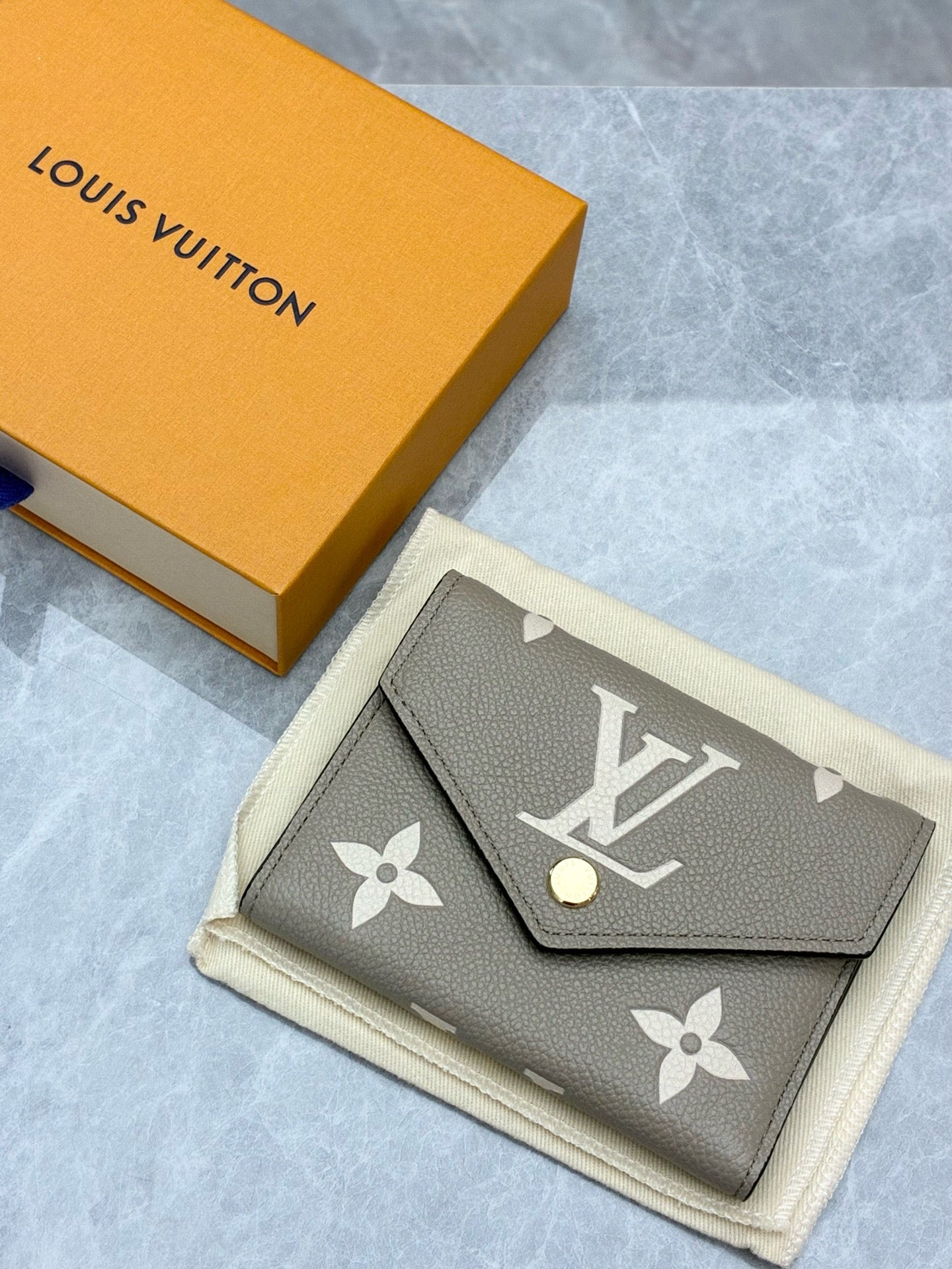 LOUIS VUITTON Victorine Wallet – Elephant Grey Monogram Empreinte, Gold Hardware, Brand New