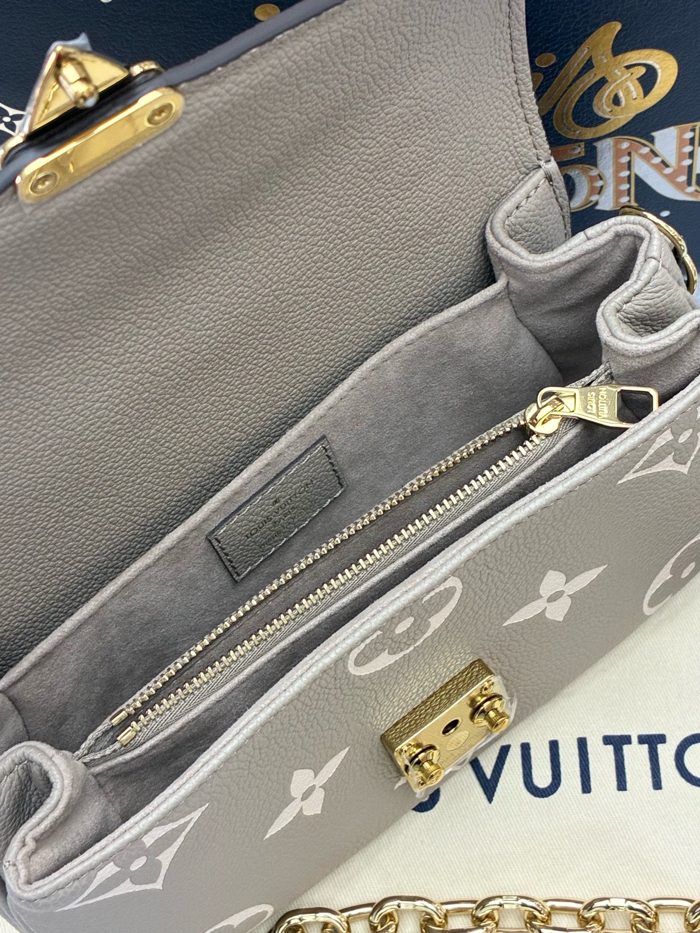 LOUIS VUITTON Pochette Métis East West – Elephant Grey Monogram Empreinte, Gold Hardware, Brand New
