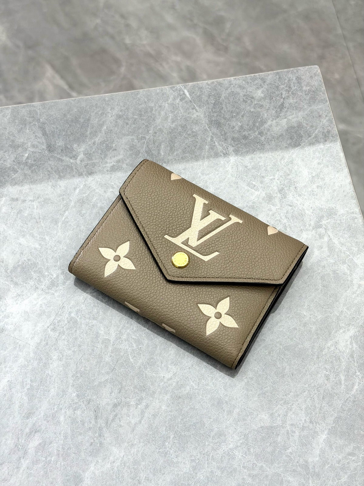 LOUIS VUITTON Victorine Trifold Wallet – Elephant Grey Monogram Empreinte with Gold-Tone Snap, Good Pre-Owned