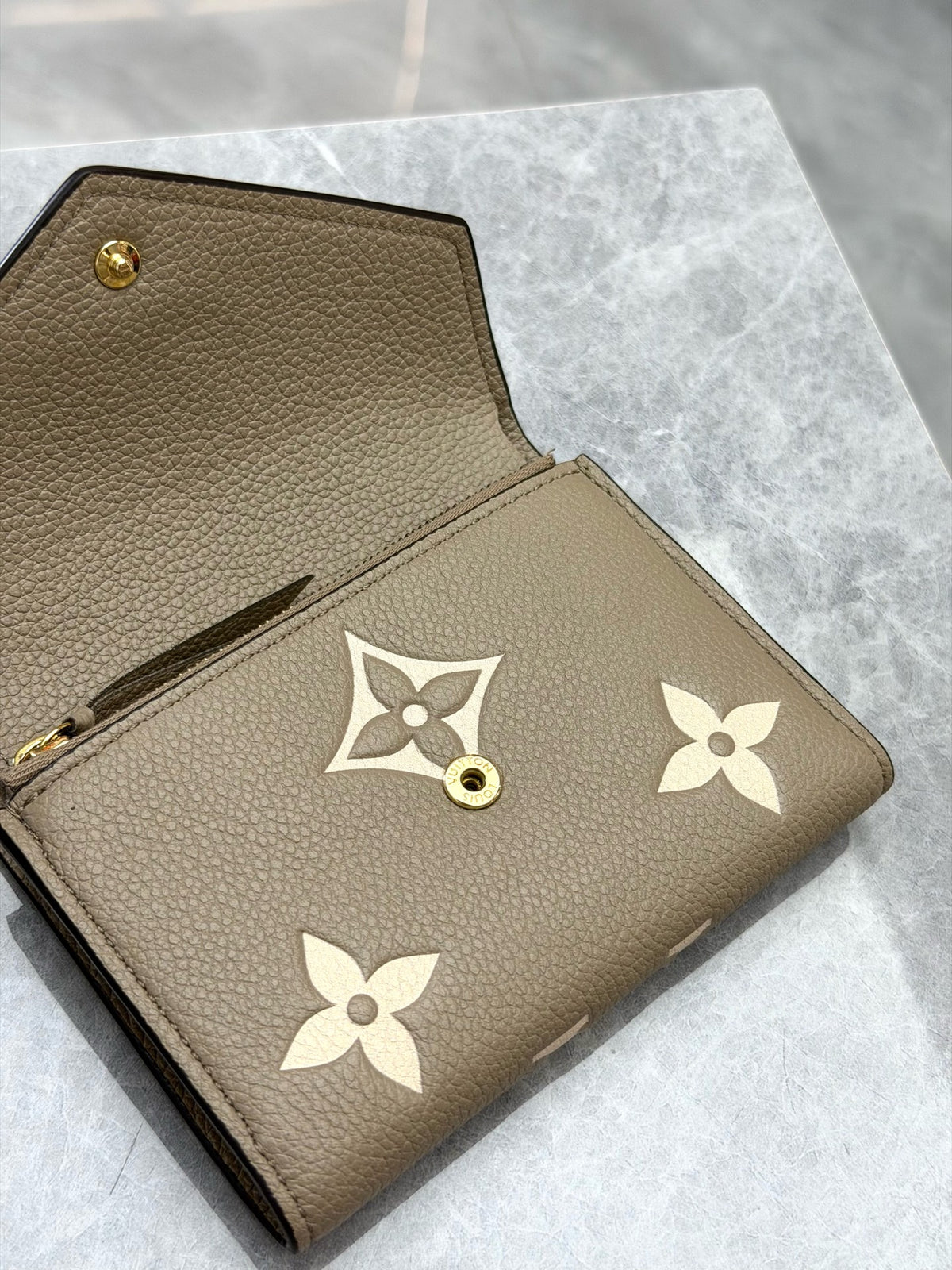 LOUIS VUITTON Victorine Trifold Wallet – Elephant Grey Monogram Empreinte with Gold-Tone Snap, Good Pre-Owned