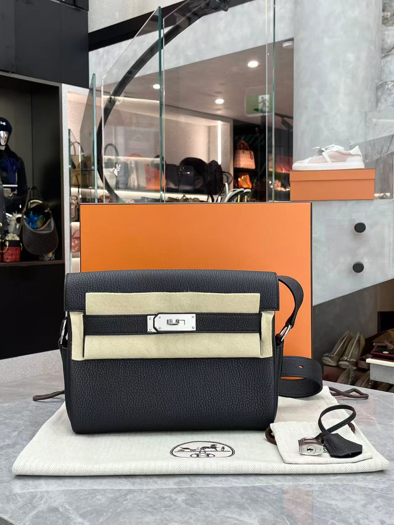 Hermès Kelly Black Messenger PM bag crafted from Togo leather with palladium-plated hardware