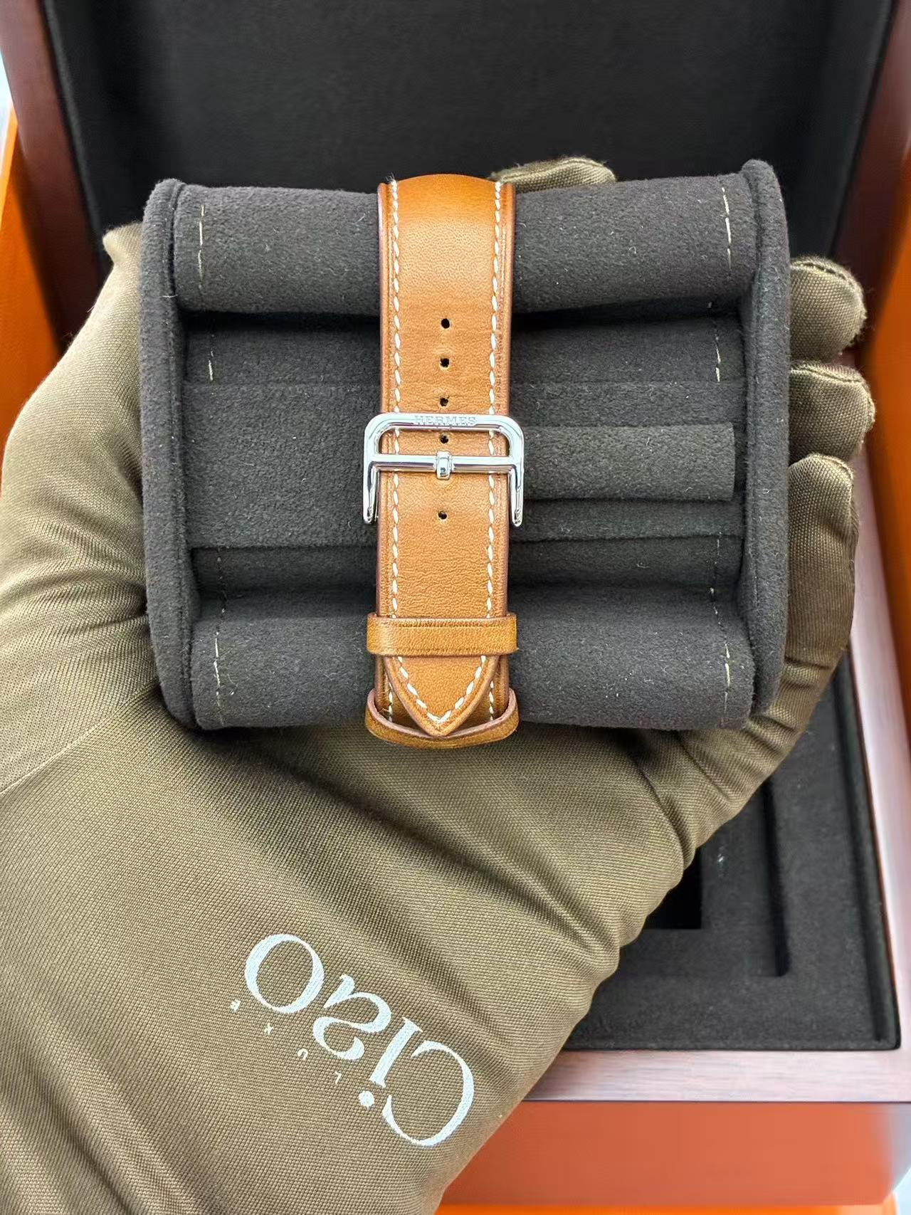 Hermès Arceau Chronograph 42mm watch featuring a white silvered dial, blue counters, and a brown leather strap