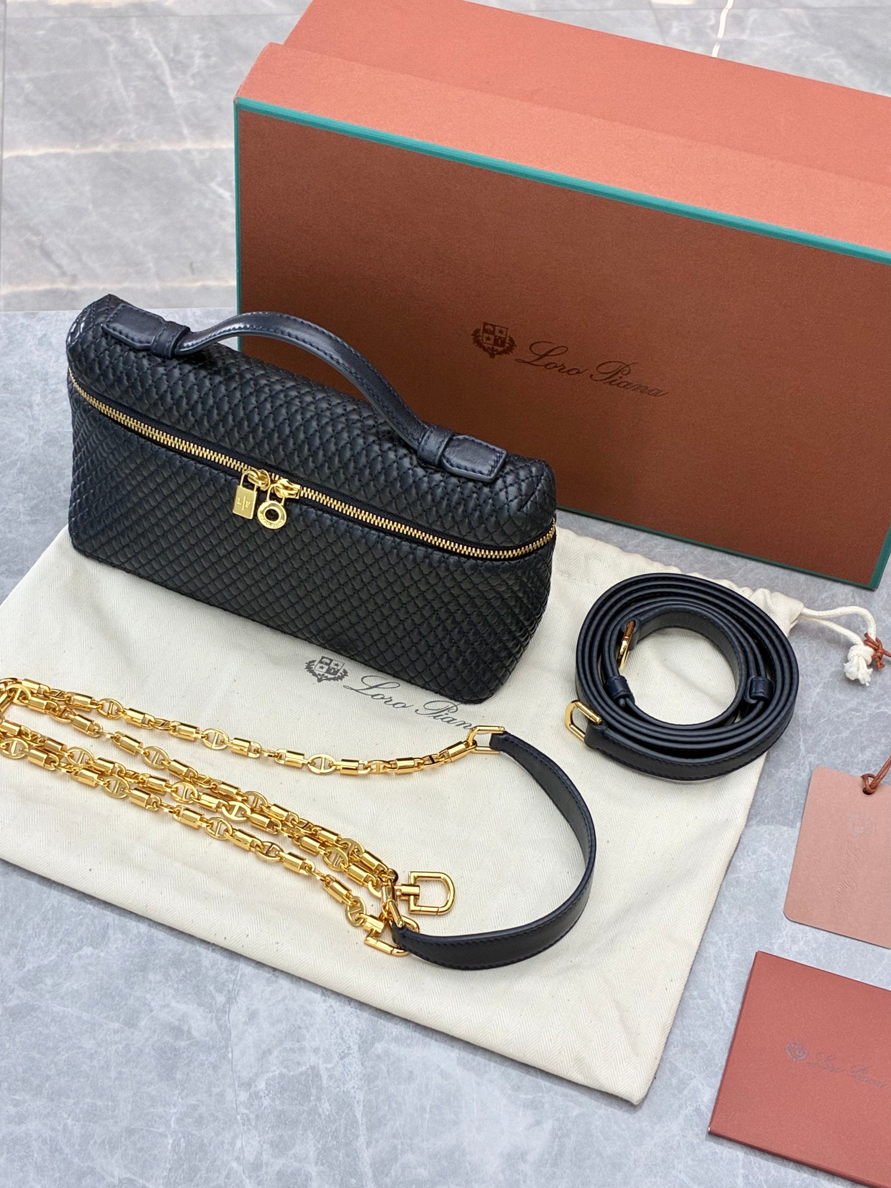 Loro Piana Extra Pocket L19 quilted leather pouch, featuring a structured silhouette with top handle and detachable strap