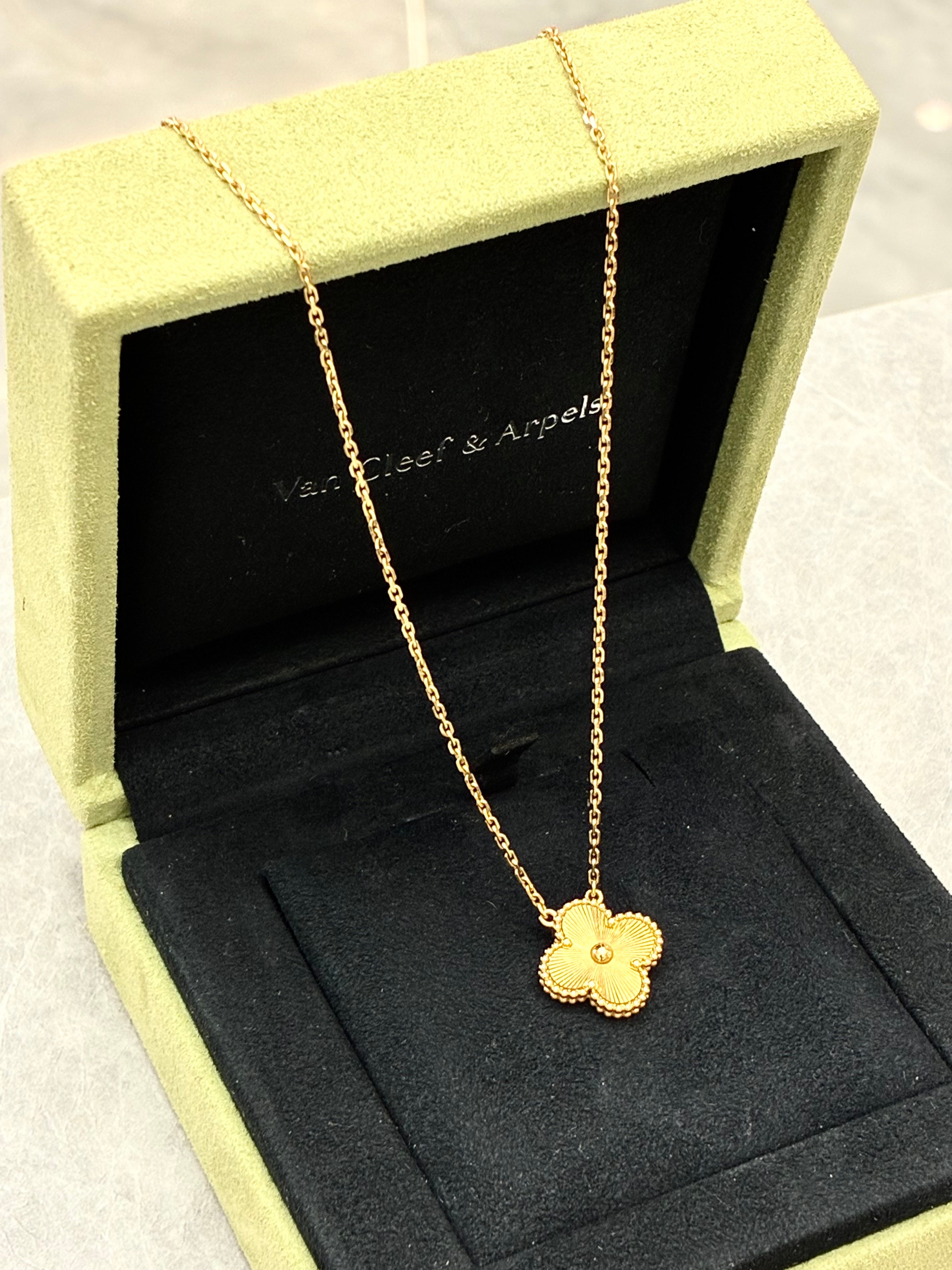 Van Cleef & Arpels Vintage Alhambra pendant necklace features a clover motif crafted in 18K yellow gold with a guilloché pattern