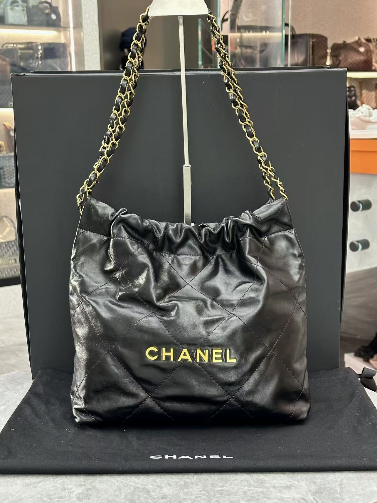 Chanel black 22 handbag crafted from shiny calfskin leather and gold-tone hardware
