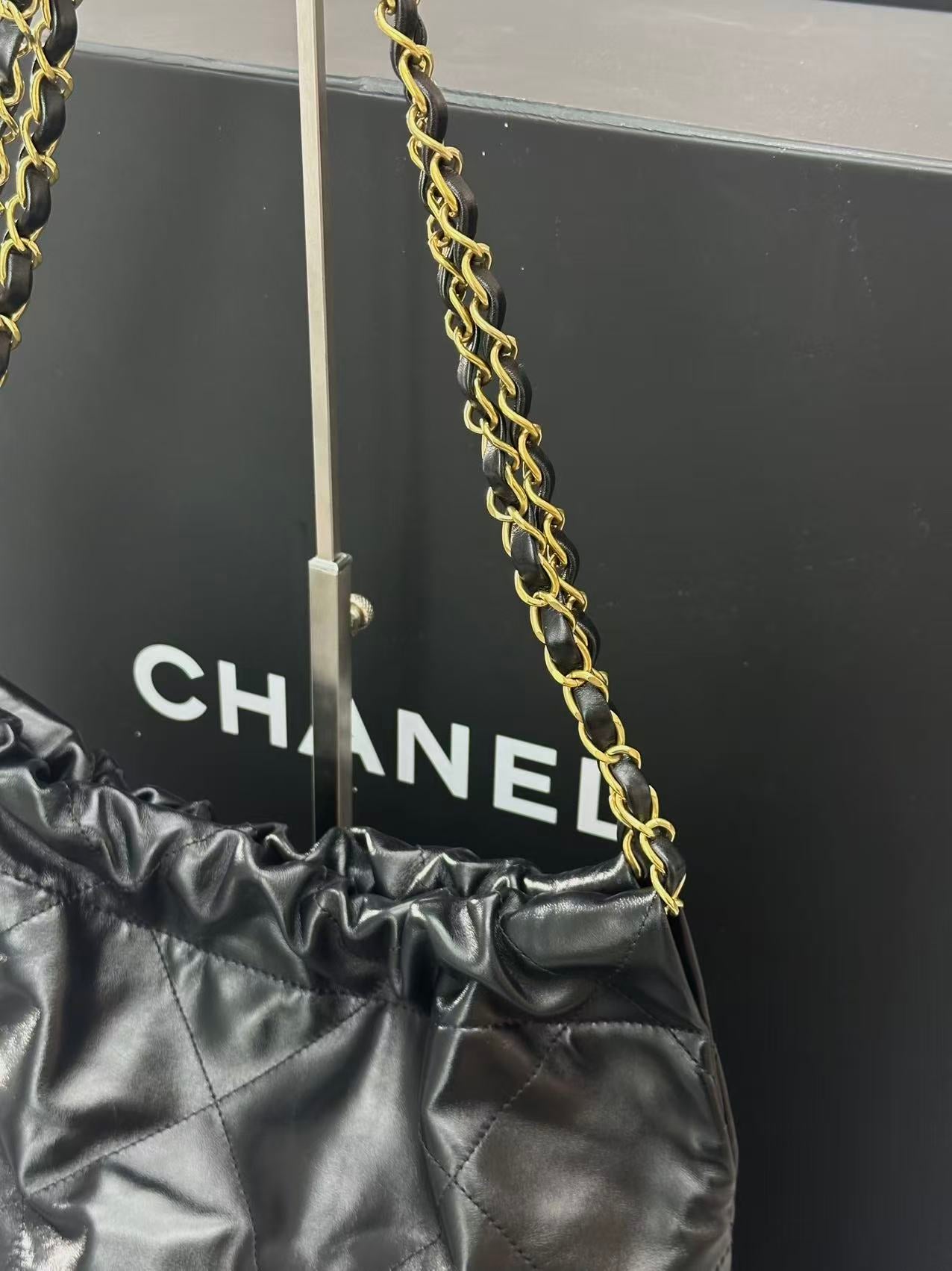 Chanel black 22 handbag crafted from shiny calfskin leather and gold-tone hardware