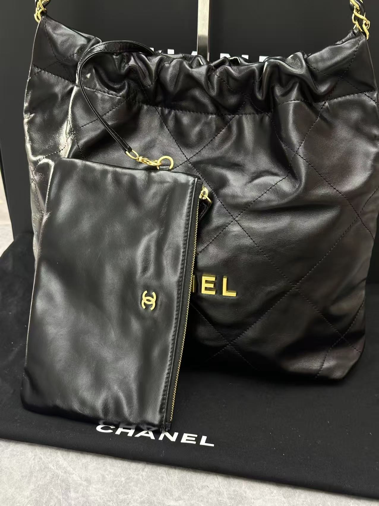 Chanel black 22 handbag crafted from shiny calfskin leather and gold-tone hardware