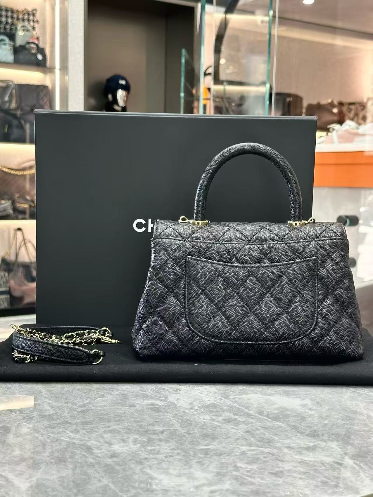 Chanel Coco Handle handbag, featuring quilted caviar leather, a top handle, and light gold-tone hardware