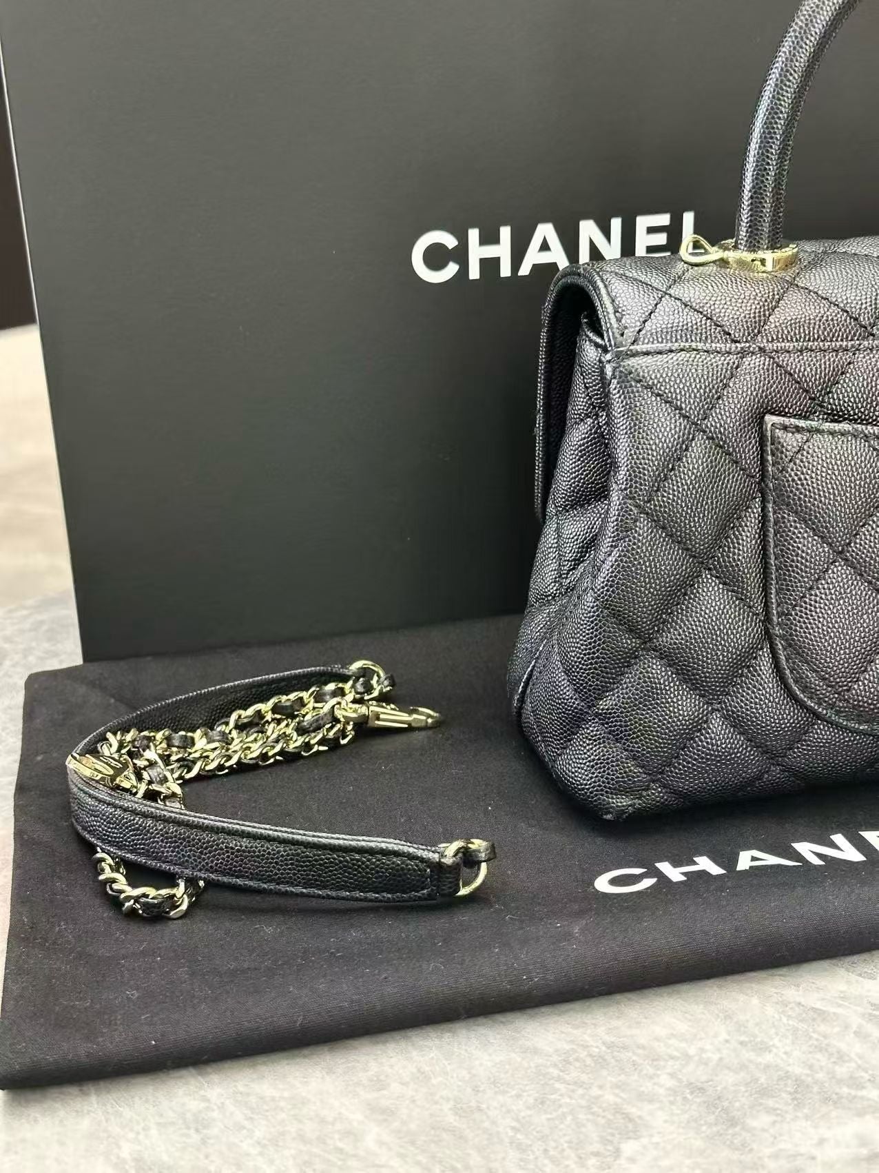 Chanel Coco Handle handbag, featuring quilted caviar leather, a top handle, and light gold-tone hardware