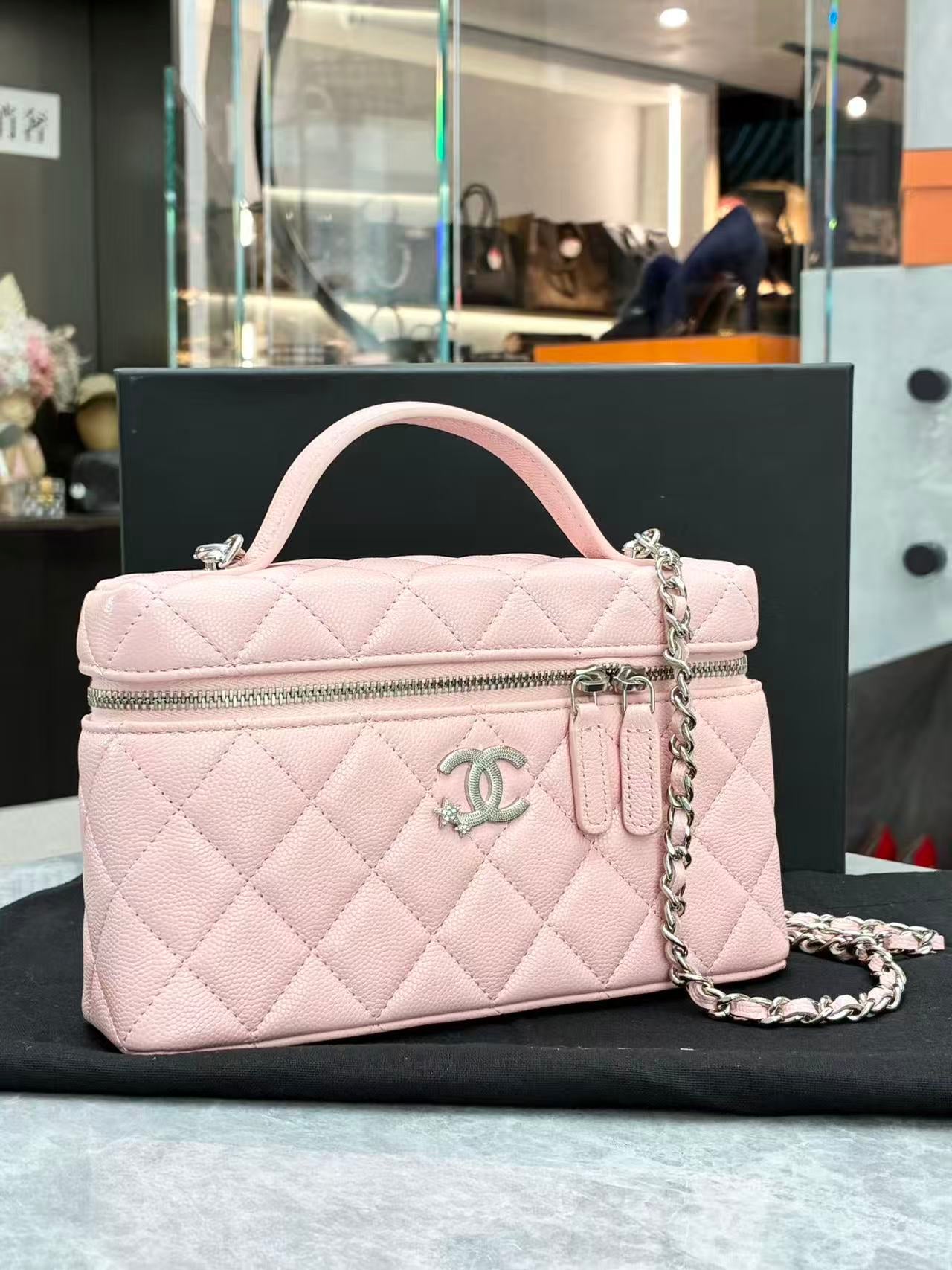 Chanel 25B pink quilted vanity case with removable chain strap, angled view