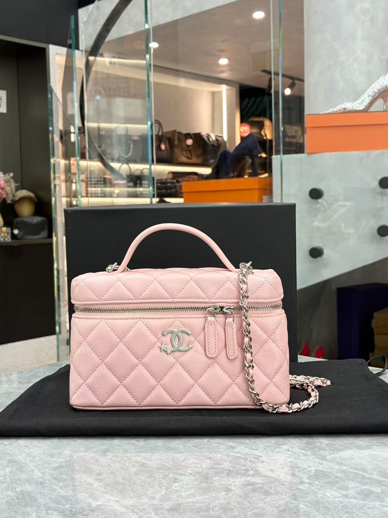 Chanel 25B pink quilted vanity case with silver-tone star CC hardware, front view