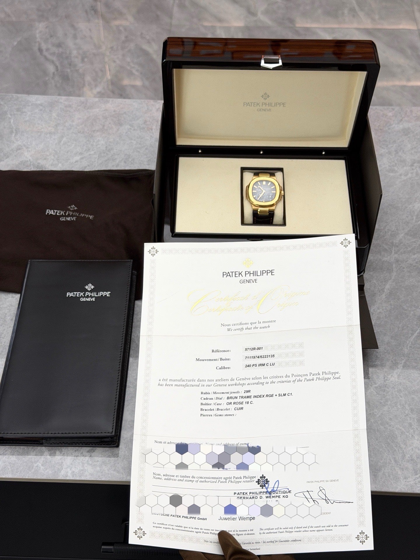 PATEK PHILIPPE Nautilus 5712R-001 – 18K Rose Gold, Black Dial with Moonphase, Power Reserve and Date, 40 mm, Excellent Pre-Owned