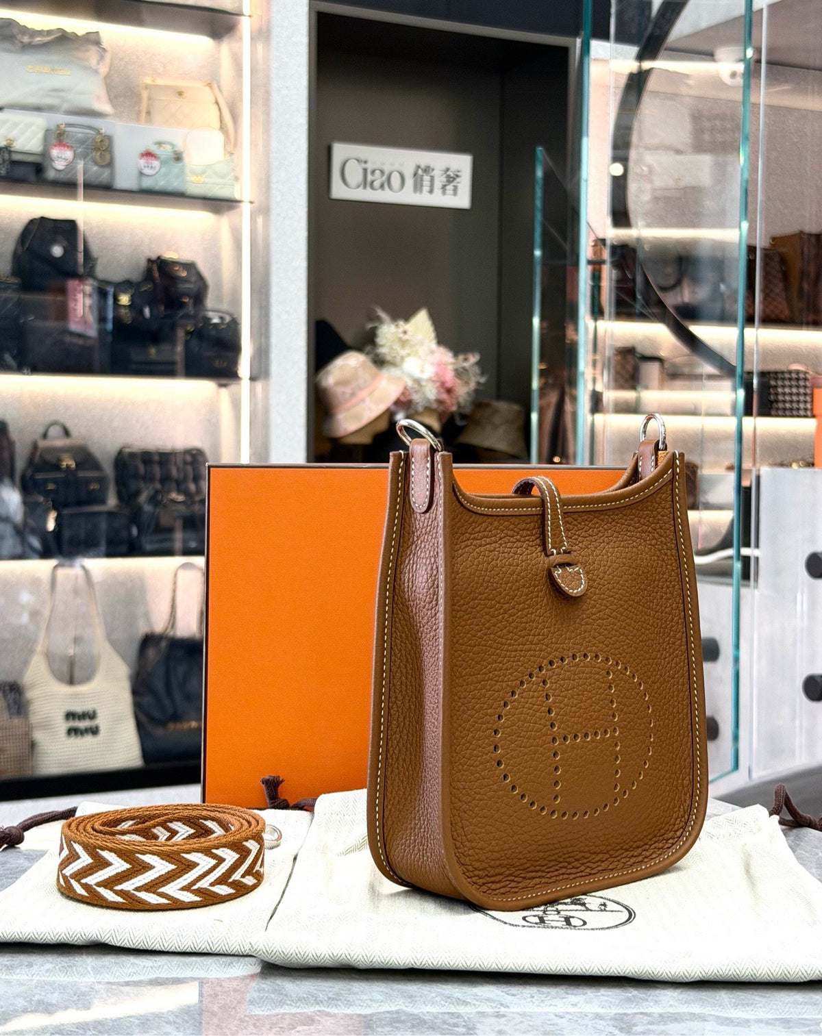 HERMÈS Mini Evelyne – Gold Taurillon Clemence, Palladium Hardware, Geometric Woven Strap, U Stamp, Brand New