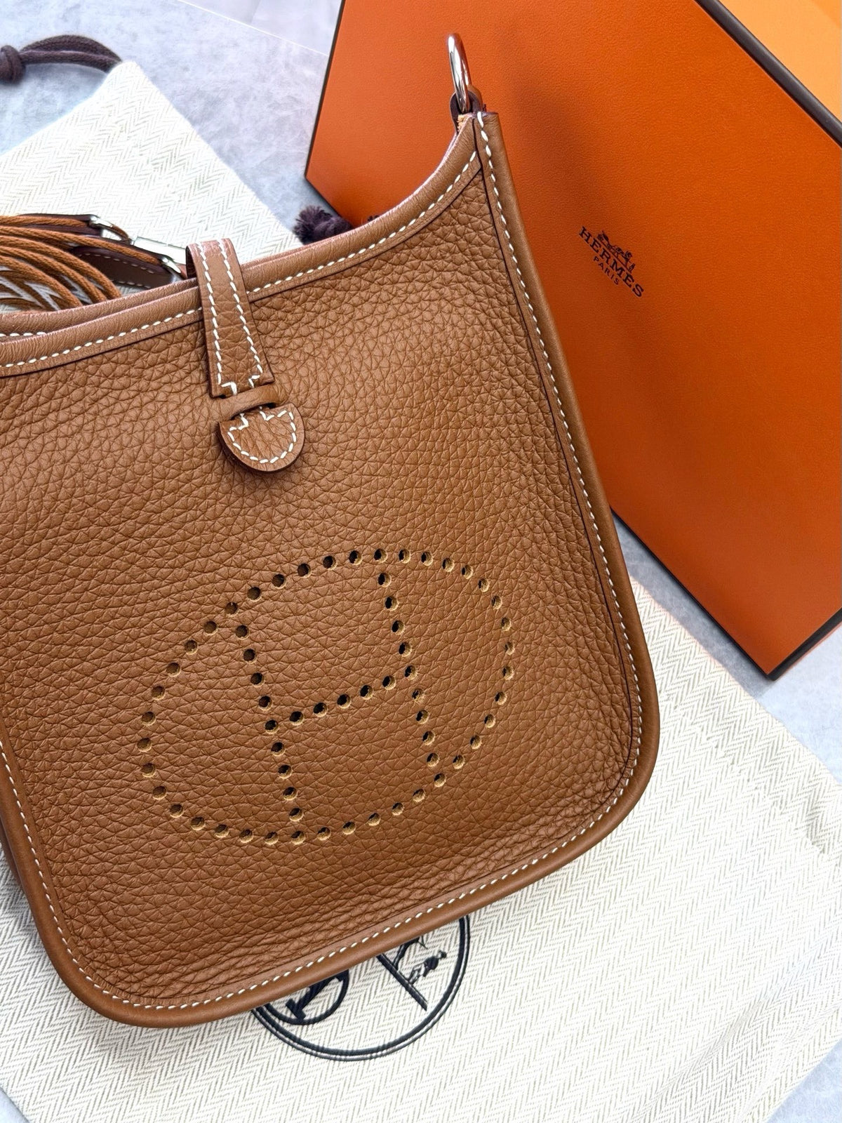 HERMÈS Mini Evelyne – Gold Taurillon Clemence, Palladium Hardware, Geometric Woven Strap, U Stamp, Brand New
