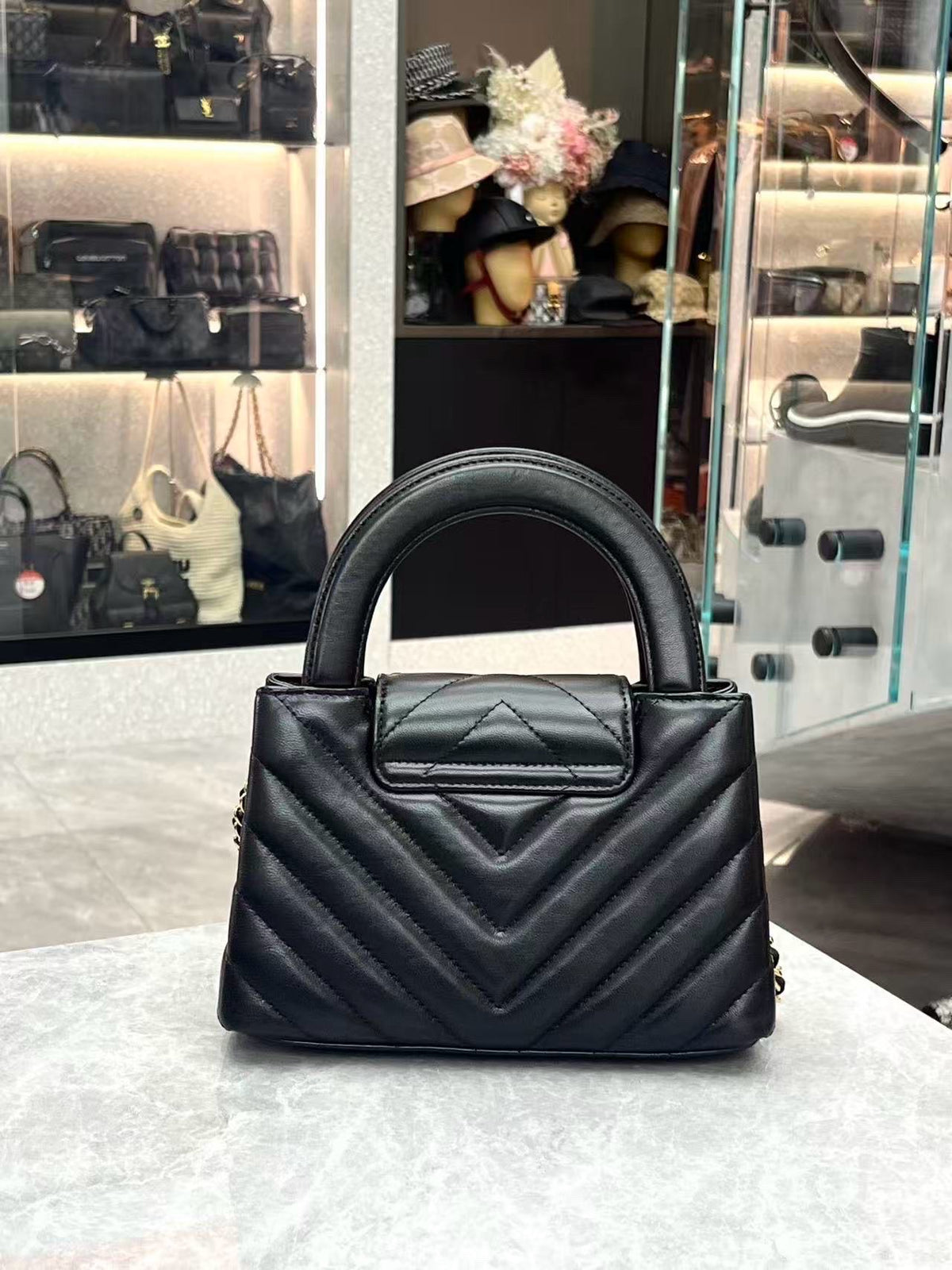 CHANEL Kelly Top Handle Flap – Black Chevron-Quilted Lambskin, Gold Hardware, Very Good Pre-Owned