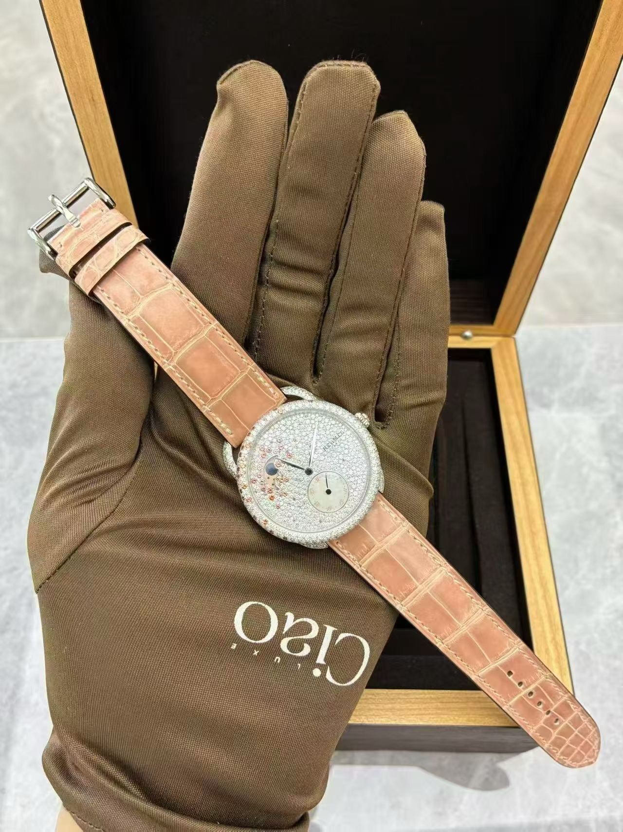 Hermès Arceau Petite Lune watch with a diamond-set white gold case and a matching pink alligator strap