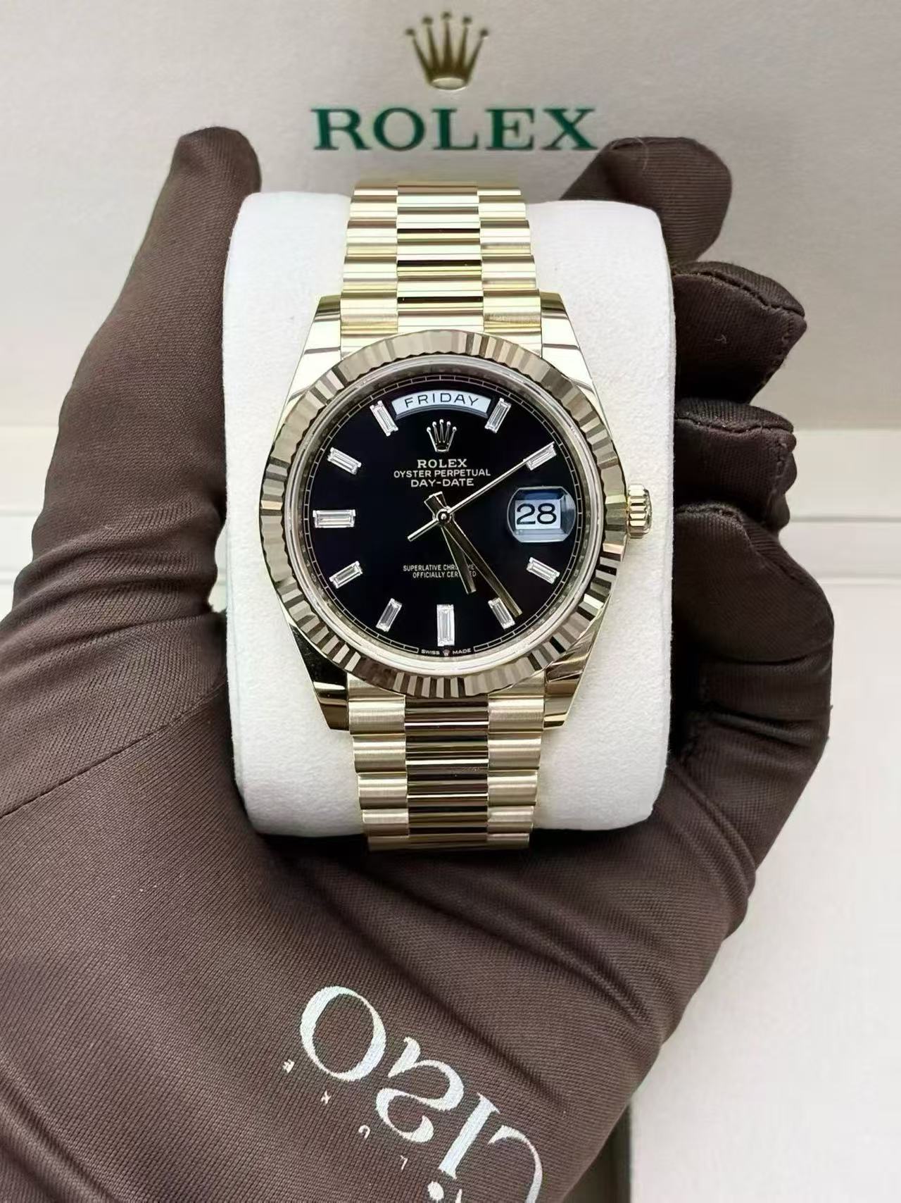 Day-Date 40 Oyster, 40 mm, yellow gold, with a black dial and baguette diamond markers