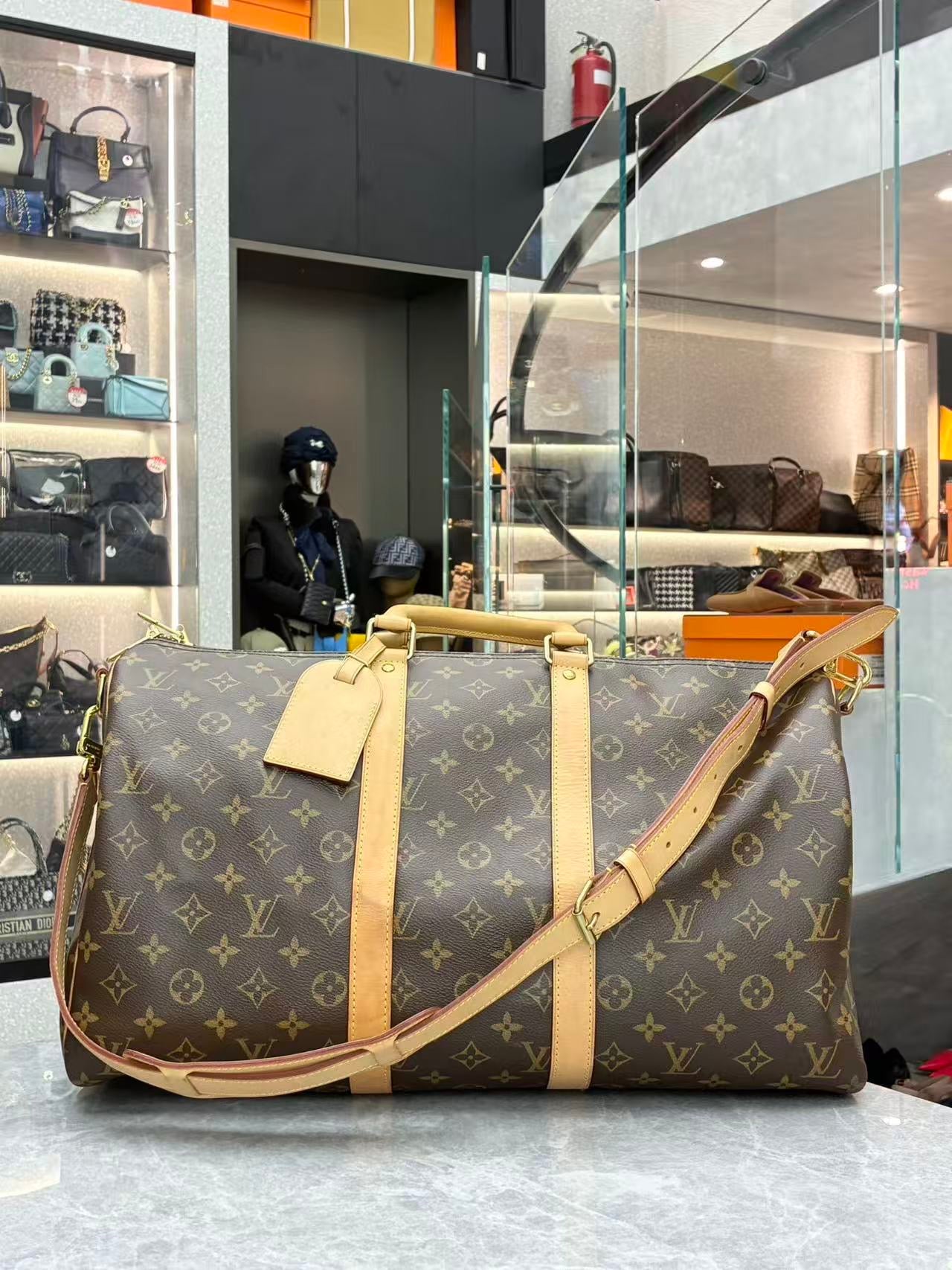 Louis Vuitton Keepall Bandoulière 45 in signature brown monogram canvas with natural cowhide leather trim