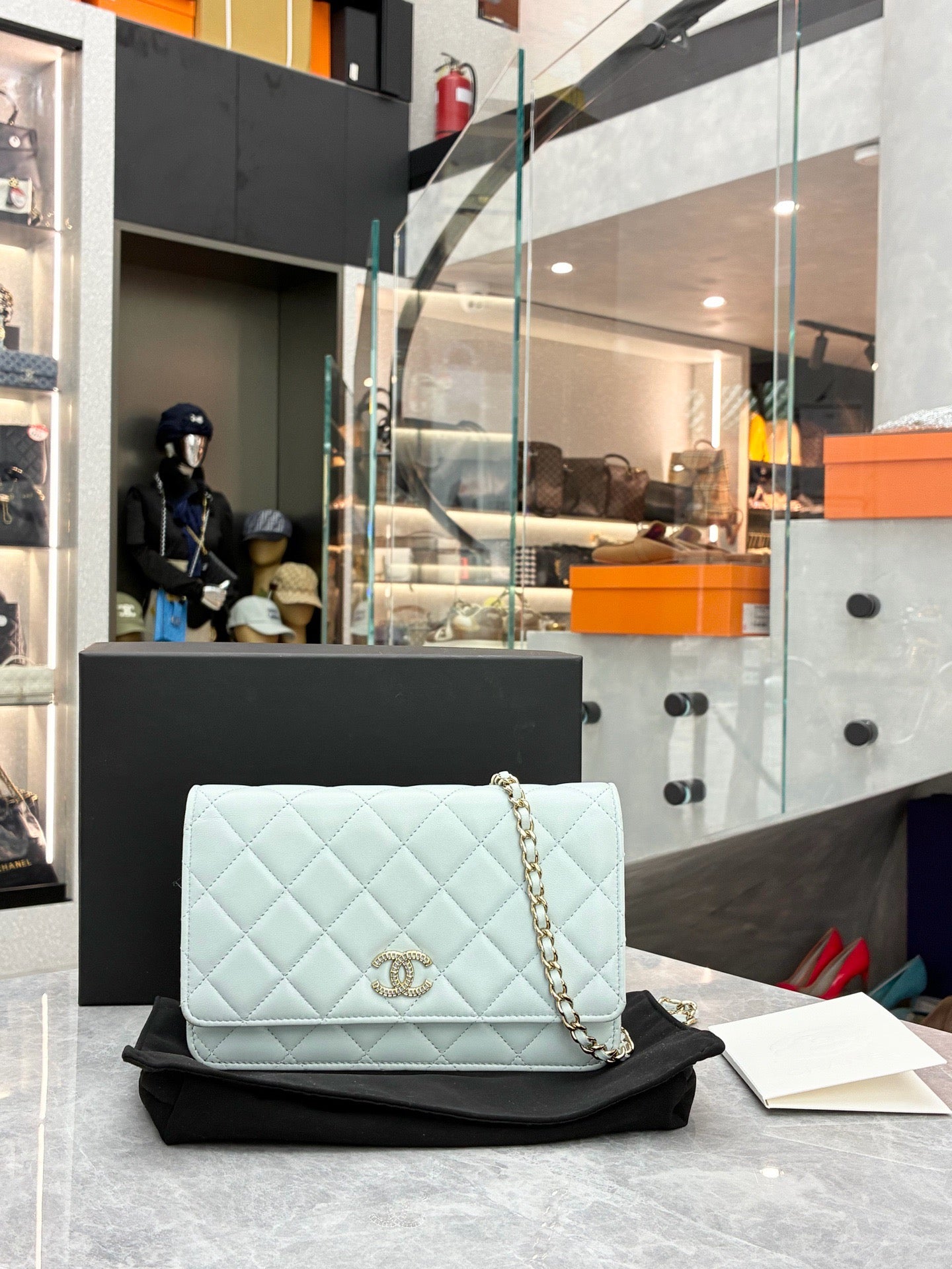 This is a Chanel Classic Wallet on Chain in light blue caviar leather
