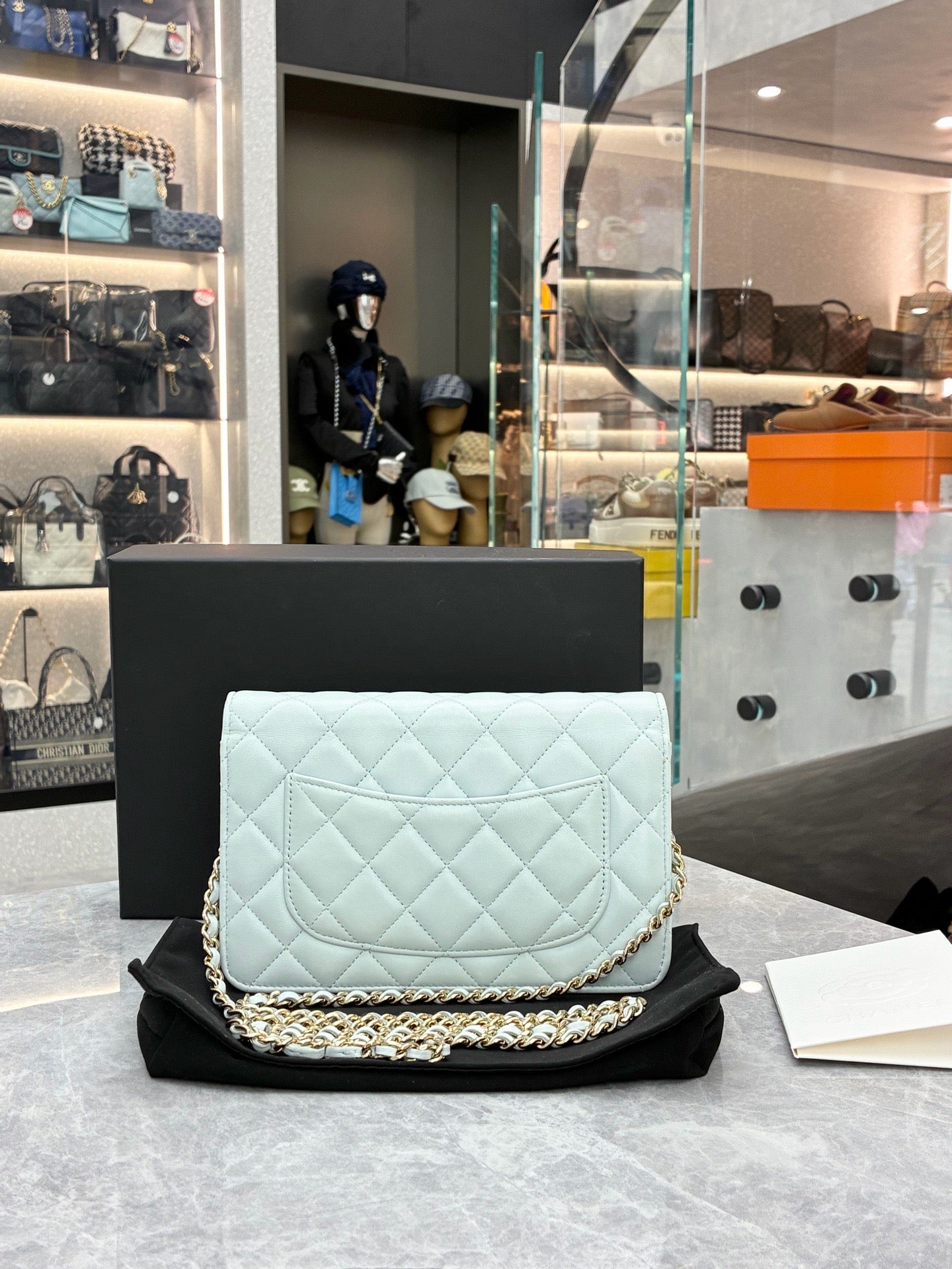 This is a Chanel Classic Wallet on Chain in light blue caviar leather