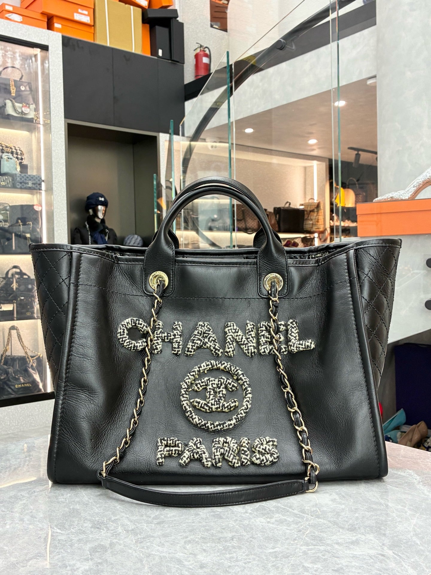 Chanel Deauville studded tote bag crafted from black caviar leather