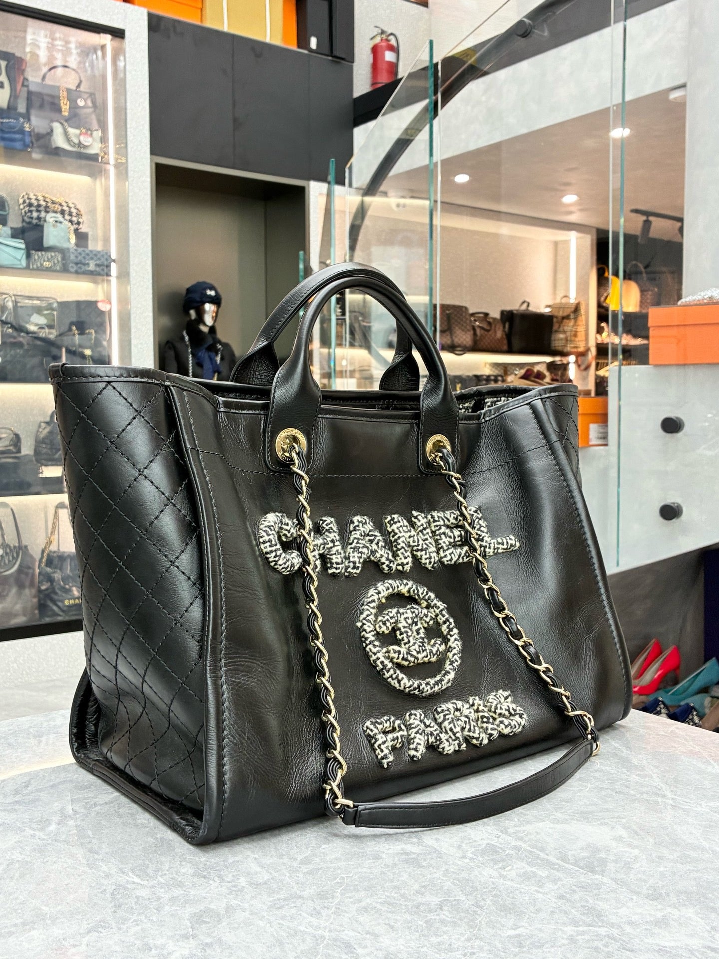 Chanel Deauville studded tote bag crafted from black caviar leather