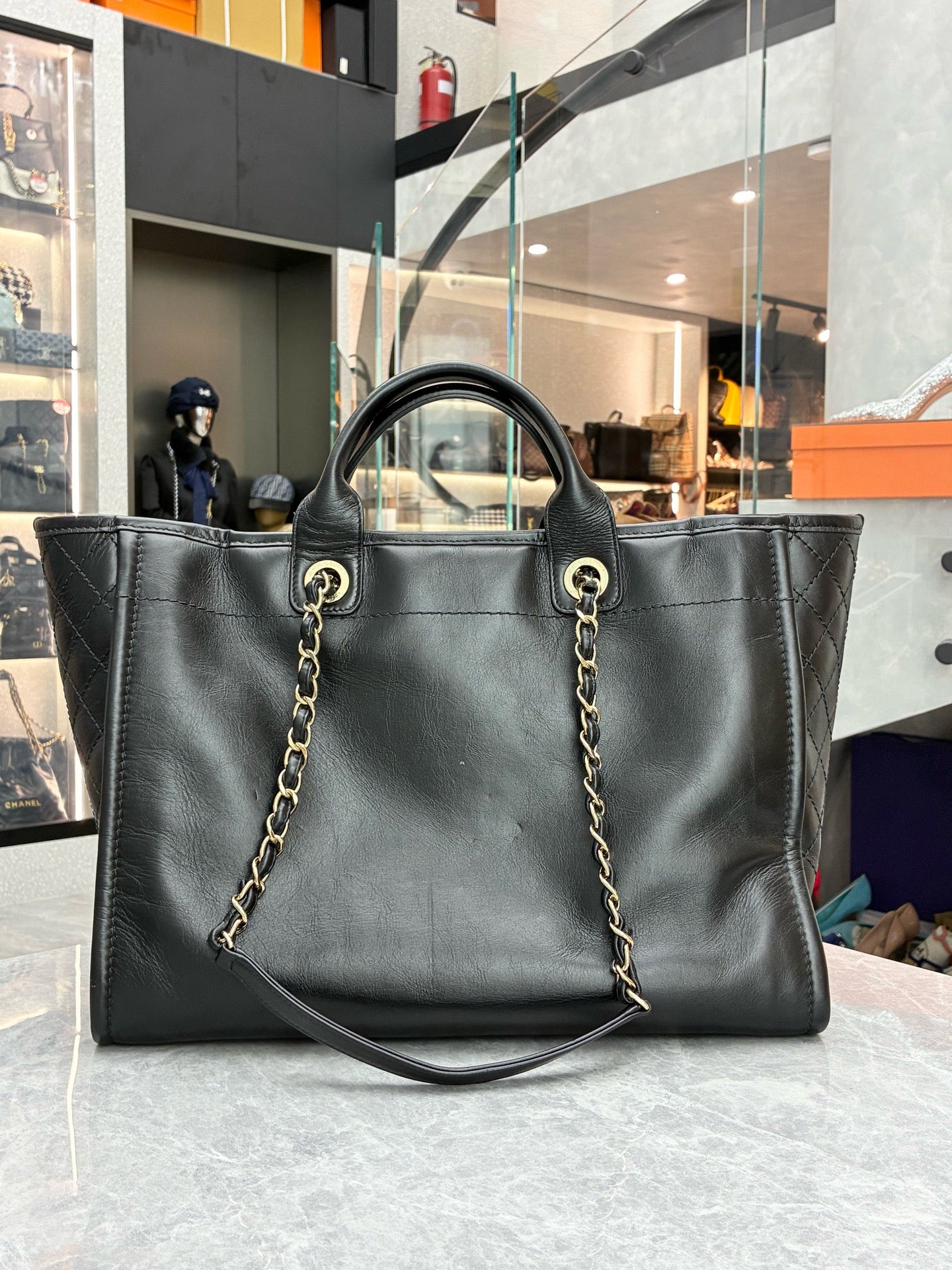 Chanel Deauville studded tote bag crafted from black caviar leather