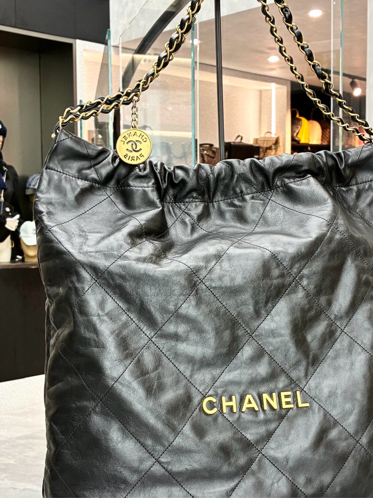 Chanel 22 black handbag crafted from shiny calfskin leather with gold-tone hardware