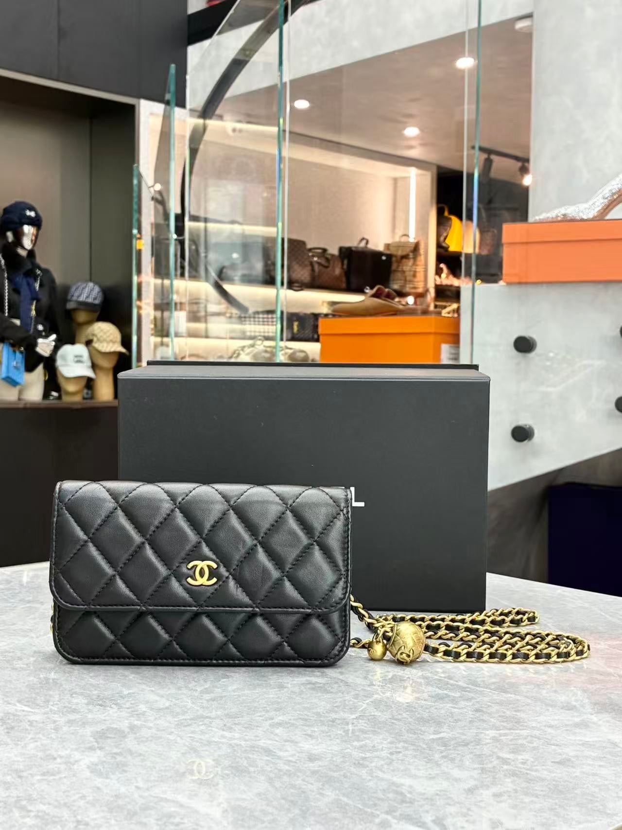 Chanel quilted lambskin wallet on chain, specifically the "Pearl Crush" variant featuring a distinctive adjustable ball charm on the chain strap