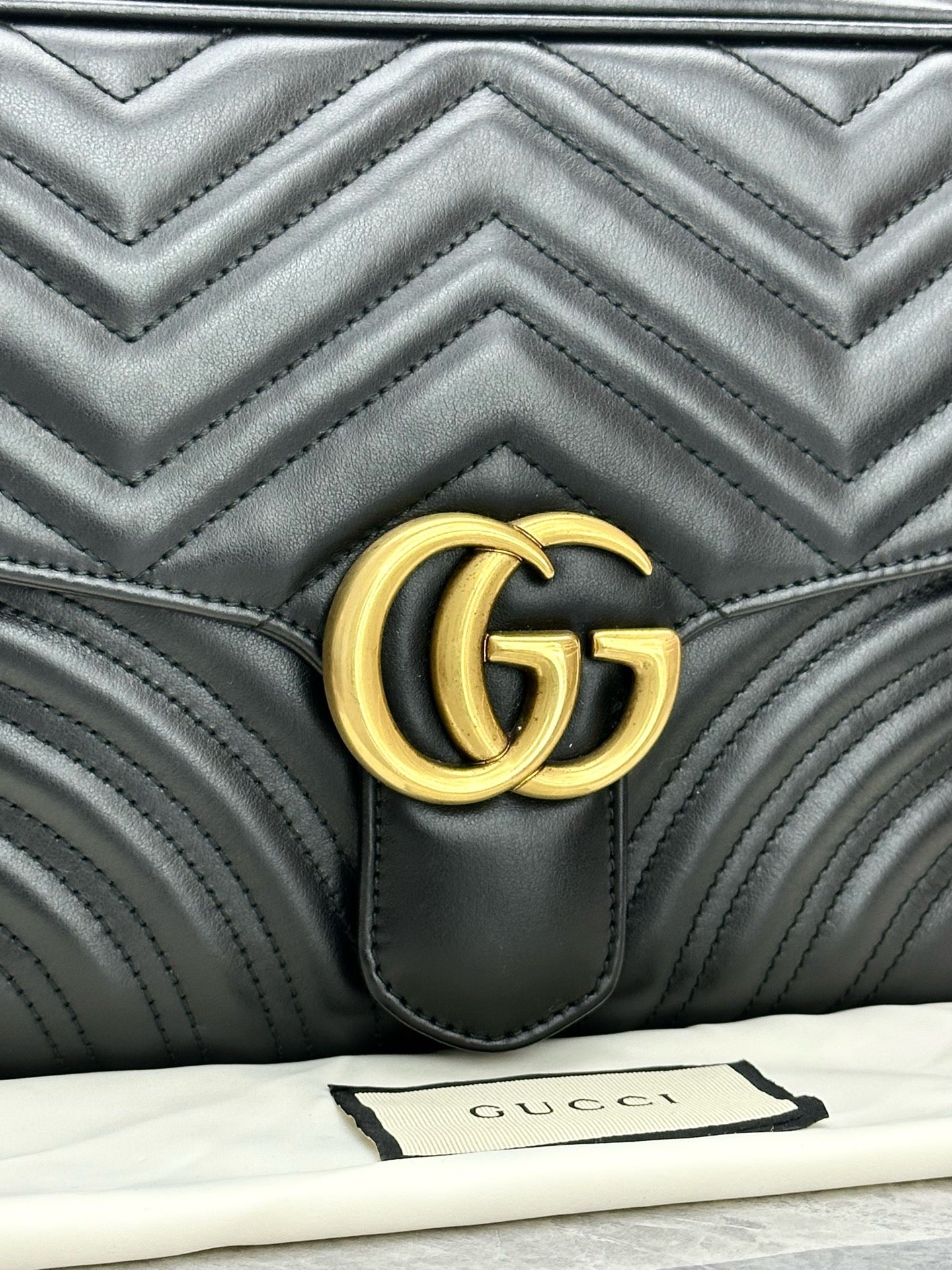Gucci GG Marmont Small Top Handle Bag in black chevron matelassé leather with gold-toned hardware