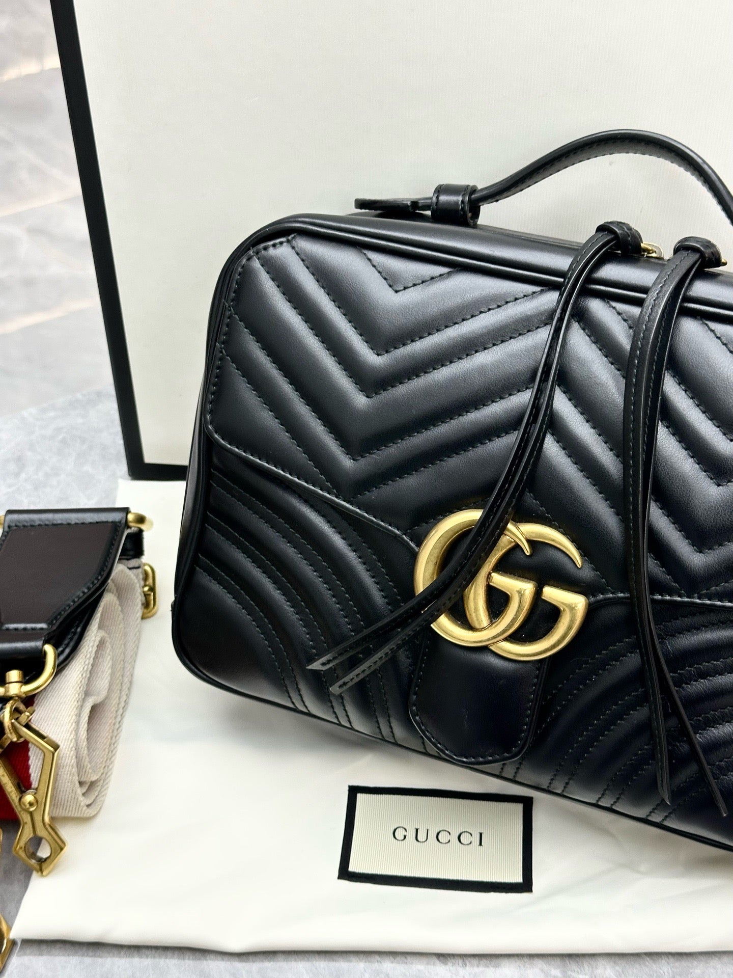 Gucci GG Marmont Small Top Handle Bag in black chevron matelassé leather with gold-toned hardware