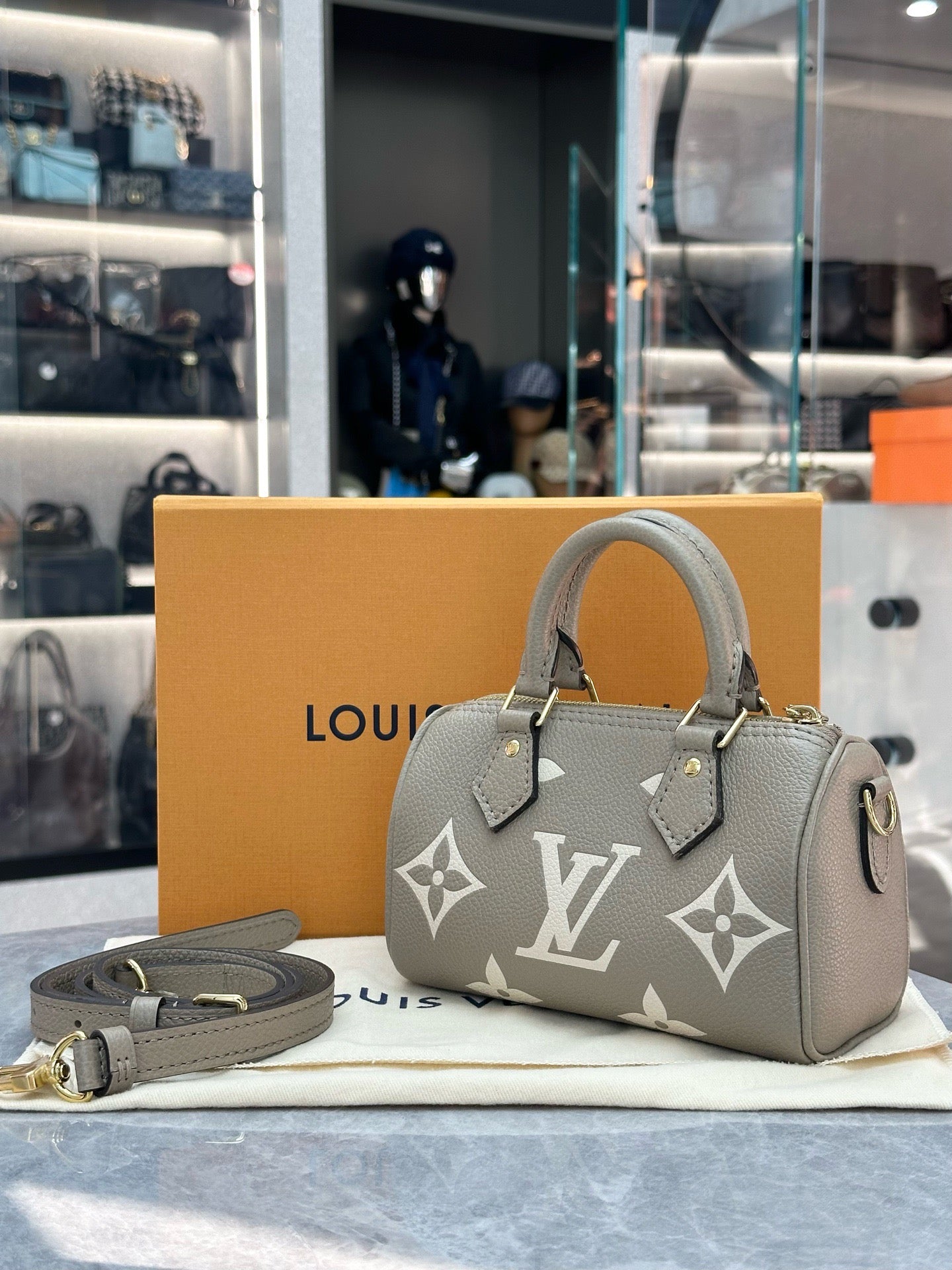 Louis Vuitton Nano Speedy handbag in Tourterelle and Creme embossed Empreinte leather