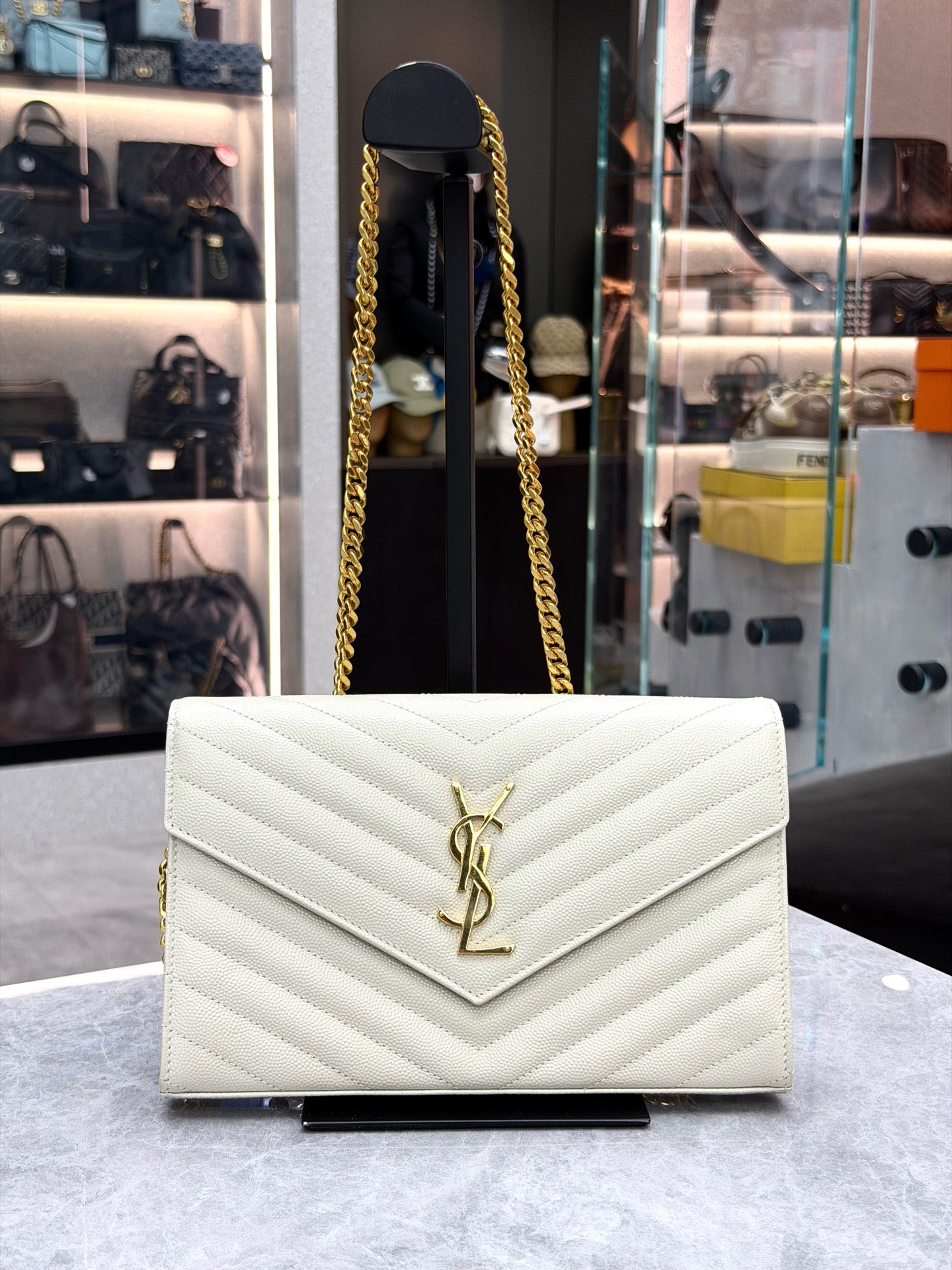 Saint Laurent Cassandre Envelope Chain Wallet crafted from white chevron-quilted leather