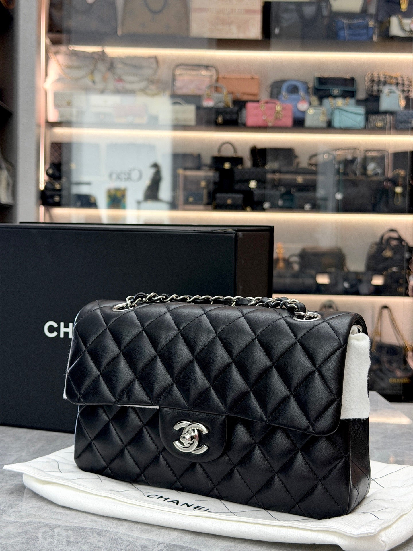 Chanel Classic Double Flap bag is crafted from black diamond-quilted lambskin leather and features silver-tone hardware